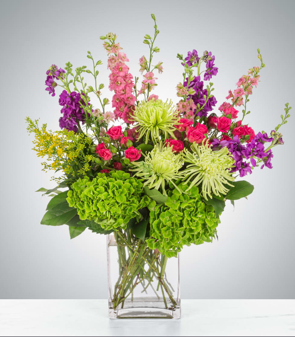 Sparklers by BloomNation™ - Featuring larkspur, spider mums, spray roses, and hydrangea this arrangement brings a brightly colored spark to anybody's life. Send it for birthdays, congratulations, and more.  Approximate Dimensions: 15"D x 18"H