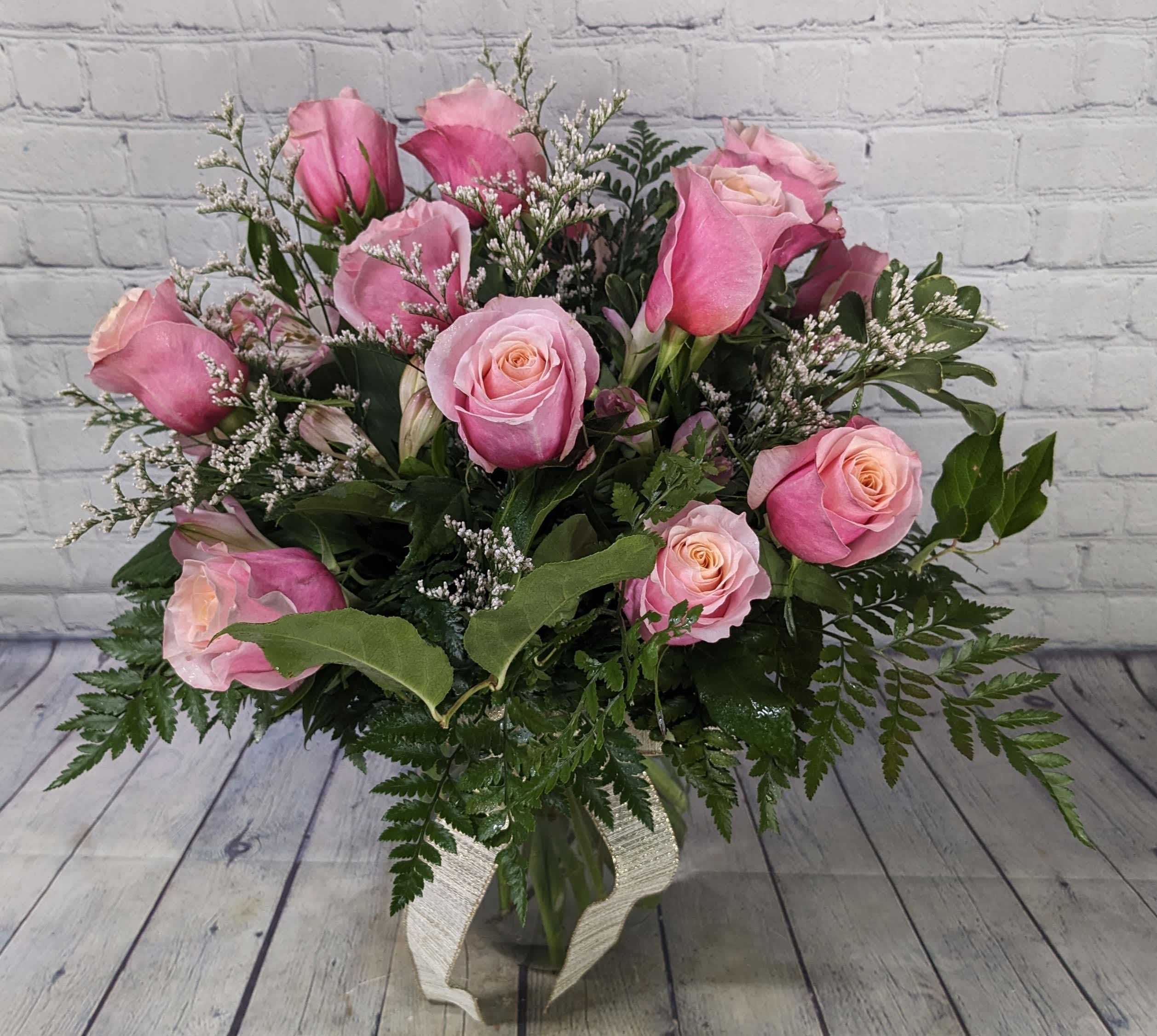 Dozen Long Stemmed Pink Roses - A dozen pink roses are a classic romantic gift. They will be perfect for Valentine's Day, an anniversary, or to just say, "I love you".  The shade of pink is dependent upon availability. 