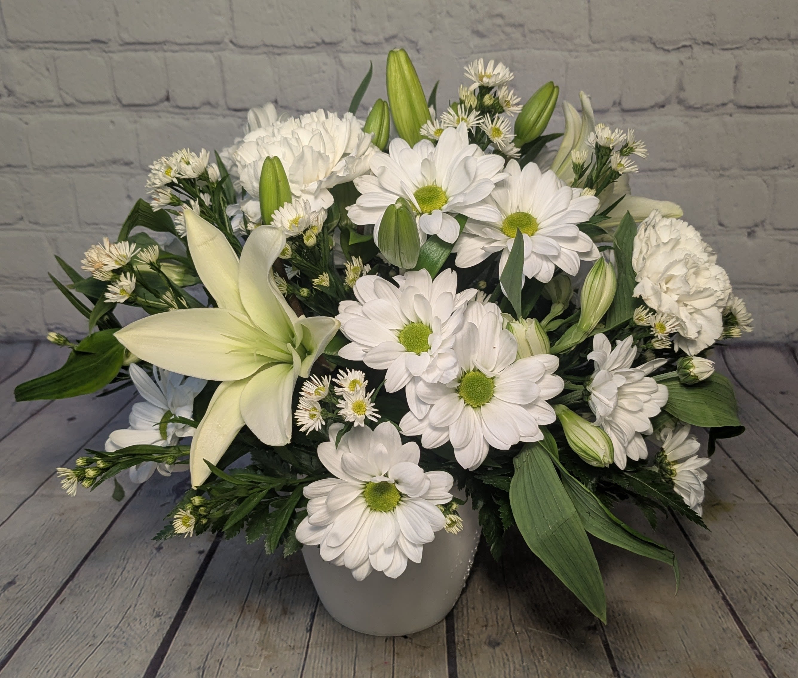 The Sweetest Kind - Simple, fresh, and full of heart—The Sweetest Kind is a charming all-white bouquet featuring white lilies, daisies, monte, alstroemeria, and carnations. Soft and serene, it's the perfect way to share a little kindness, comfort, or love.