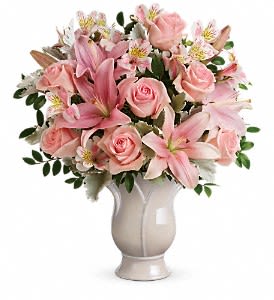Teleflora's Soft And Tender Bouquet DX - Tender as a rose, this soft pink arrangement is a beautifully feminine show of love. Pink roses, pink asiatic lilies, and pink alstroemeria are accented with dusty miller and huckleberry. Delivered in Teleflora's Blooming Tulip vase. Orientation: All-Around