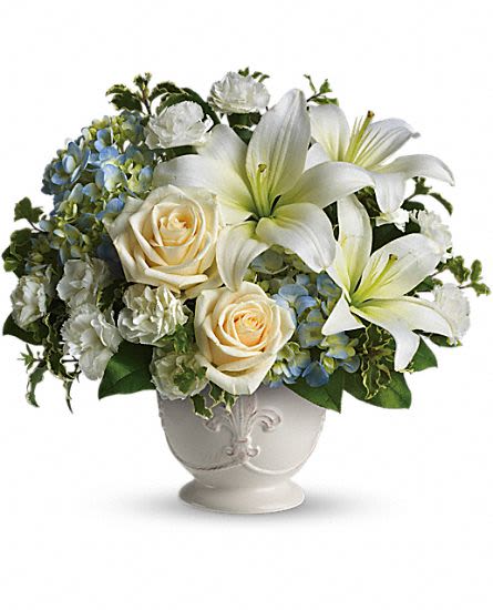 Beautiful Dreams - This French country style sympathy arrangement communicates your condolences in a most heartfelt way. It''s a lovely choice when you want to send flowers to family or friends. A beautiful bouquet of blue and white sympathy flowers - blue hydrangeas, crème roses, white miniature carnations, fragrant white asiatic lilies and green pitta negra - are delivered in a French Country Pot. Approximately 13" W x 12" H This item is hand-arranged and delivered byour florist. All prices in U.S. Dollars. Orientation:One-Sided