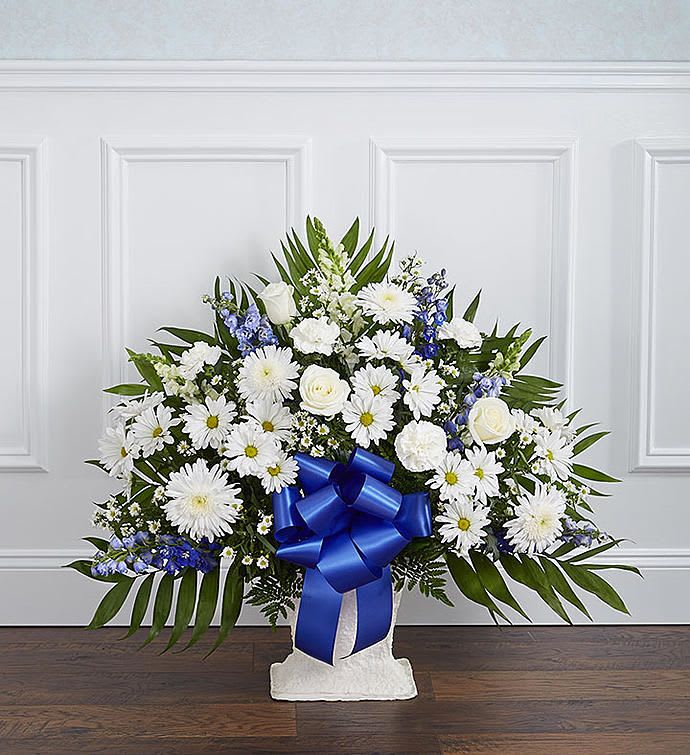 Heartfelt Tribute Floor Basket - Offer a peace and tranquility that comes from classic blue and white flowers. Our elegant floor basket arrangement, handcrafted by our caring florists with rich blue delphinium and crisp white blooms, is a tasteful gesture perfectly suited for the funeral home or memorial services. Floor basket arrangement of blue delphinium; white roses, snapdragons, cremones, carnations, daisy poms and monte casino; accented with soft, lush greenery Large arrangement measures approximately 36"H x 42"L Medium arrangement measures approximately 34"H x 40"L Small arrangement measures approximately 32"H x 36"L Appropriate for the funeral home Our florists use only the freshest flowers available, so colors and varieties may vary