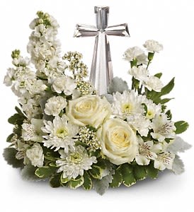 Teleflora's Divine Peace Bouquet DX - An elegant display of faith and divine peace, this beautiful arrangement will comfort the bereaved in a truly thoughtful and respectful way. An exquisite crystal cross is surrounded by a bed of lovely blossoms. It is sure to be appreciated and always remembered. A fragrant mix of pure white blooms - including roses, alstroemeria, stock, carnations and waxflower - is accented with dusty miller and variegated pittosporum around an exclusive Crystal Cross keepsake. Approximately 16 1/2" W x 13 1/2" H