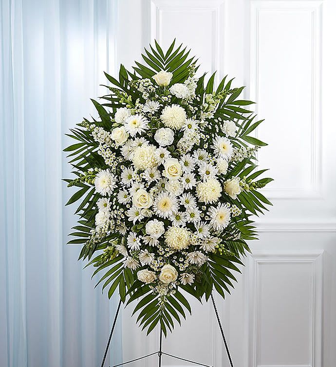 White Sympathy Standing Spray - White flowers have a peacefulness and purity to them, bringing hope and light during a time of loss. Our impressive standing spray arrangement is meticulously handcrafted by expert local florists with an abundance of pristine white blooms for a lush, full presentation. Let it be a grand and memorable tribute to one who was loved so dearly.