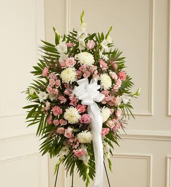 Deepest Sympathies Standing Spray-Pink &amp; White - This Sympathy Standing Spray, in shades of peach, orange and white, is a beautiful symbol of your sympathy and support.  Pink roses, stargazer lilies, spray roses, white carnations and more An appropriate gift for family, friends and business associates to send directly to the funeral home Our florists use only the freshest flowers available so colors and varieties may vary Large measures approximately 54"H x 42"L without easel Medium measures approximately 46"H x 38"L without easel Small measures approximately 42"H x 32"L without easel