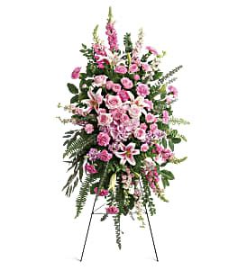 Glorious Farewell Spray - Glorify a life well-lived with this magnificent spray of pink hydrangea, roses and lilies--a radiant, reflective celebration of her beauty and love. This glorious spray includes pink hydrangea, light pink roses, light pink spray roses, pink oriental lilies, pink carnations, miniature light pink carnations, pink larkspur, pink snapdragons, pink stock, huckleberry, sword fern, asparagus plumosus and greenery. Delivered on a wire easel.