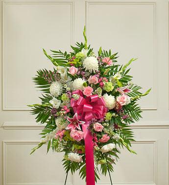 Deepest Sympathies Standing Spray - Pastel - This Sympathy Standing Spray, crafted using elegant pastel blooms, is a beautiful symbol of your sympathy and support.  Beautiful arrangement of pastel roses, lilies, mums, gladiolas, snapdragons, Bells of Ireland, carnations, heather and more An appropriate gift for family, friends and business associates to send directly to the funeral home Our florists use only the freshest flowers available so colors and varieties may vary Large measures approximately 56"H x 42"L without easel Medium measures approximately 46"H x 38"L without easel Small measures approximately 42"H x 32"L without easel