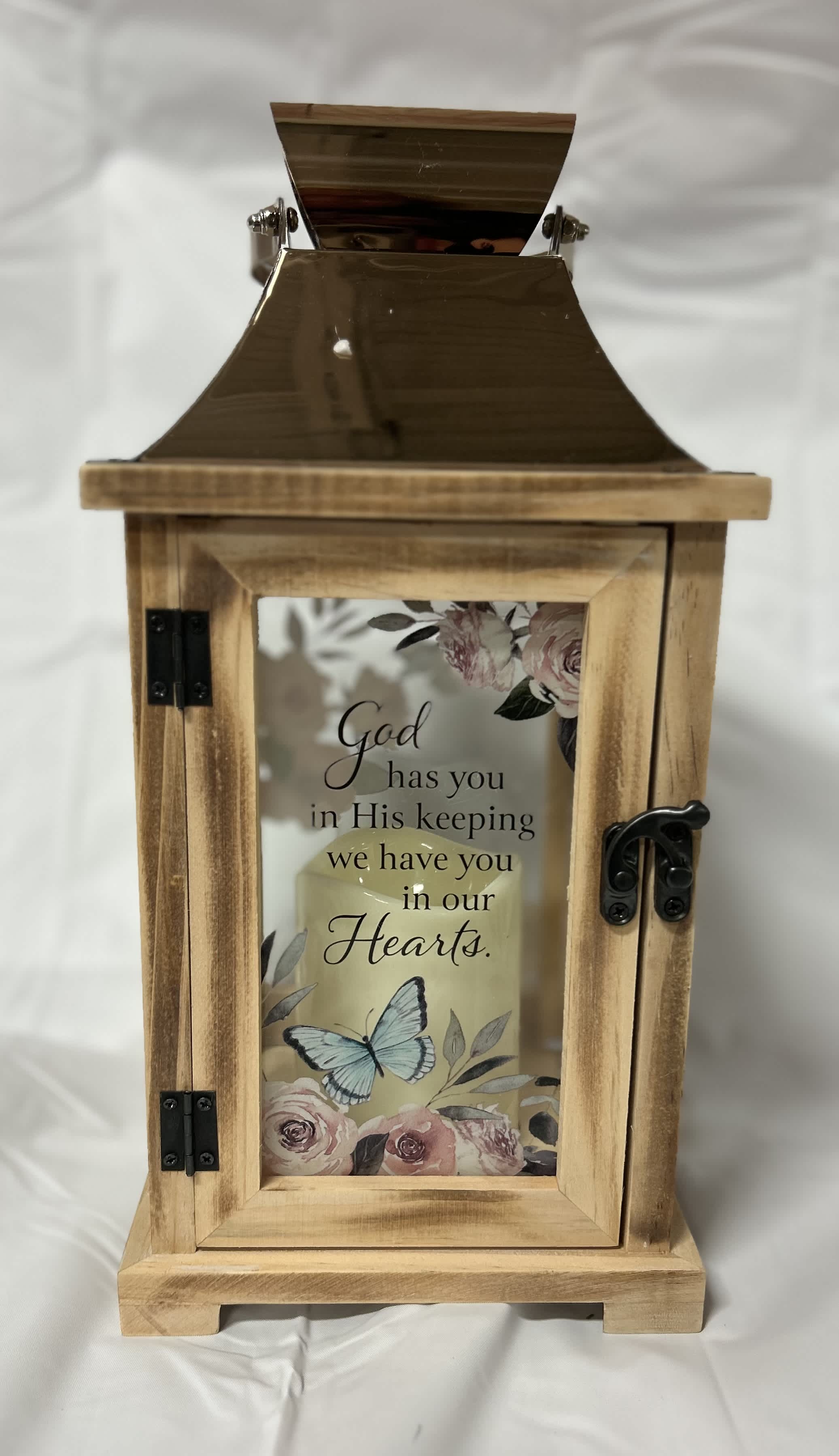 God has you in His Keeping Lantern - This wooden lantern has flowers and butterflies. The saying is "God has you in His keeping we have you in our Hearts