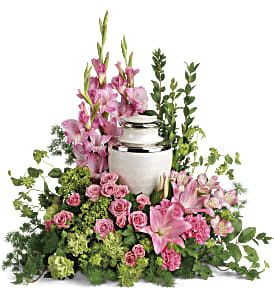 Sacred Solace Cremation Tribute - Surround the cremation urn with gorgeous, graceful pink blooms that show deep gratitude for a beautiful life. This pretty arrangement includes miniature green hydrangea, pink spray roses, pink asiatic lilies, pink alstroemeria, pink gladioli, pink carnations, green carnations, bupleurum, green ivy, myrtle, ming fern, and lemon leaf. Arrangement does not include urn. Approximately 27" W x 26" H