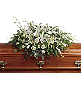 Grandest Glory Casket Spray - As serene as gently falling snow, this pure white spray of hydrangea, orchids, roses and lilies is a heartfelt symbol of peace and beauty--a symbol that will remain a guiding light to your loved ones for years to come. This stunning spray features white hydrangea, white cymbidium orchids, white dendrobium orchids, white roses, white spray roses, white oriental lilies, curly willow, green ivy, parvifolia eucalyptus, seeded eucalyptus, silver dollar eucalyptus, sword fern, and lemon leaf. Approximately 48 1/2" W x 33" H