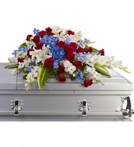 Distinguished Service Casket Spray - A beautifully patriotic way to pay tribute to a loved one. This half-couch spray sends an eloquent message of strength, respect and freedom. Brilliant flowers such as blue hydrangea, red roses, white oriental lilies and much more create this dignified way to honor the deceased. Approximately 46 1/2" W x 24" H