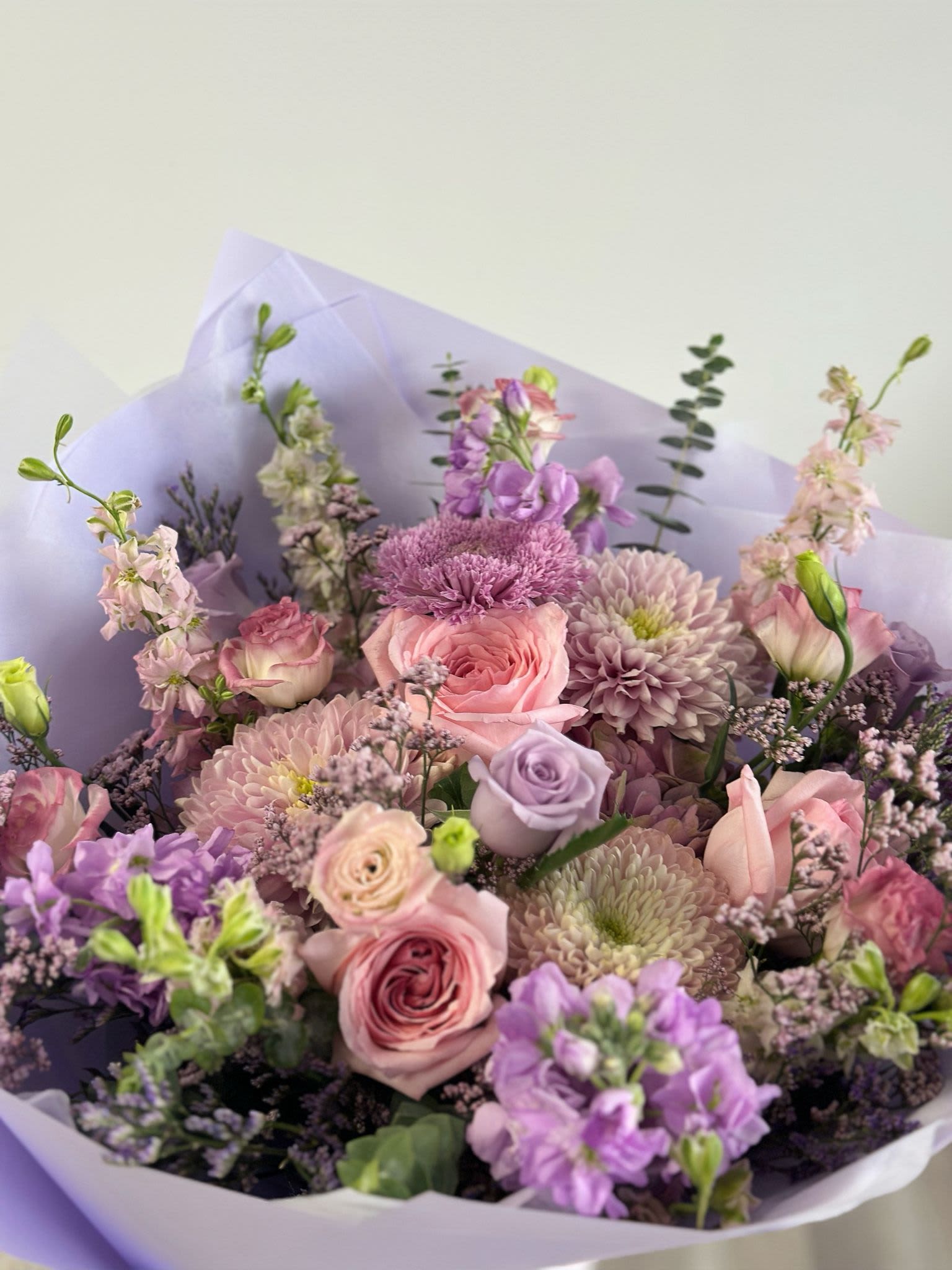 Moonlight Blush - A bouquet pastel mix of lavender and pink flowers arranged in a classic round shape.  Flower types may vary depending on the season.