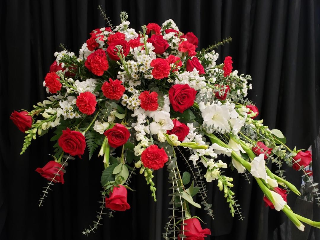 Traditional Red and White Casket - Arrangement includes White Snap Dragons, White Gladiolas, White Stock, Monte Casino, Red Roses, Red Carnations and Assorted Greenery 