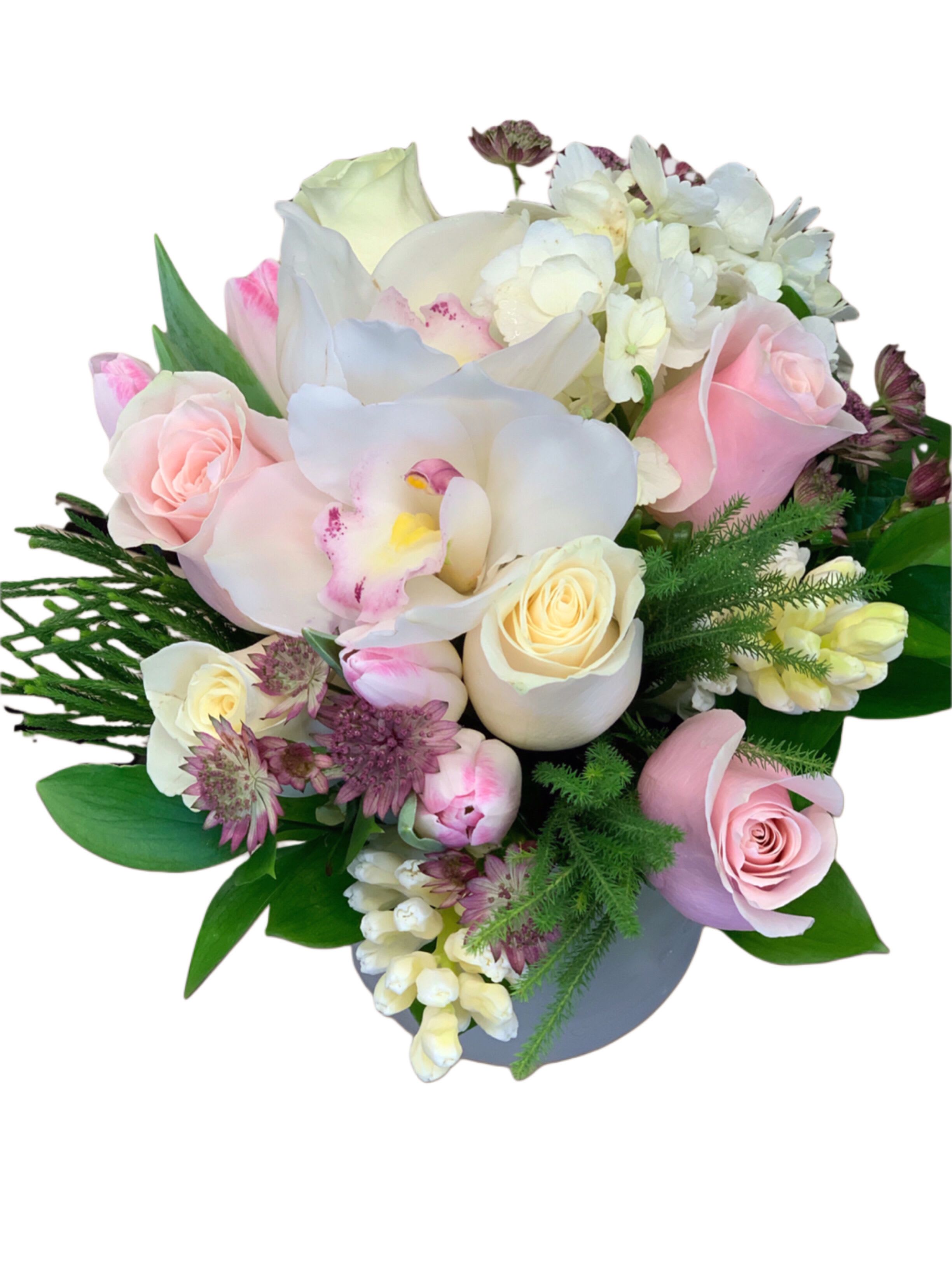 Hugs and Kisses - Soft pinks and creams in a cylinder vase, flower varieties used based on seasonal availability 