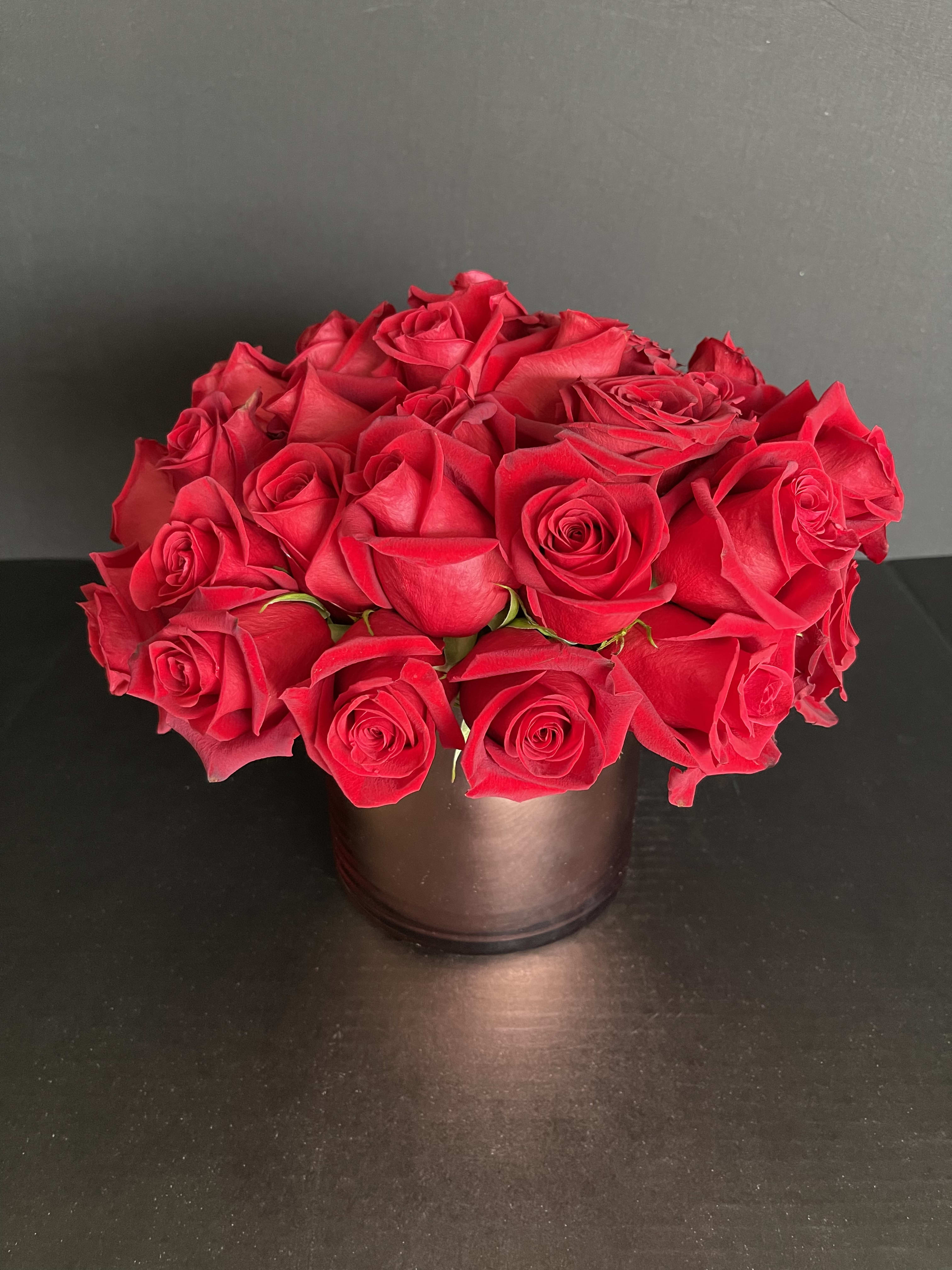 Two dozen roses. Low and Lush. ONE LEFT - Our stunning large head red roses in a short and lush design. A modern look for your Love. 