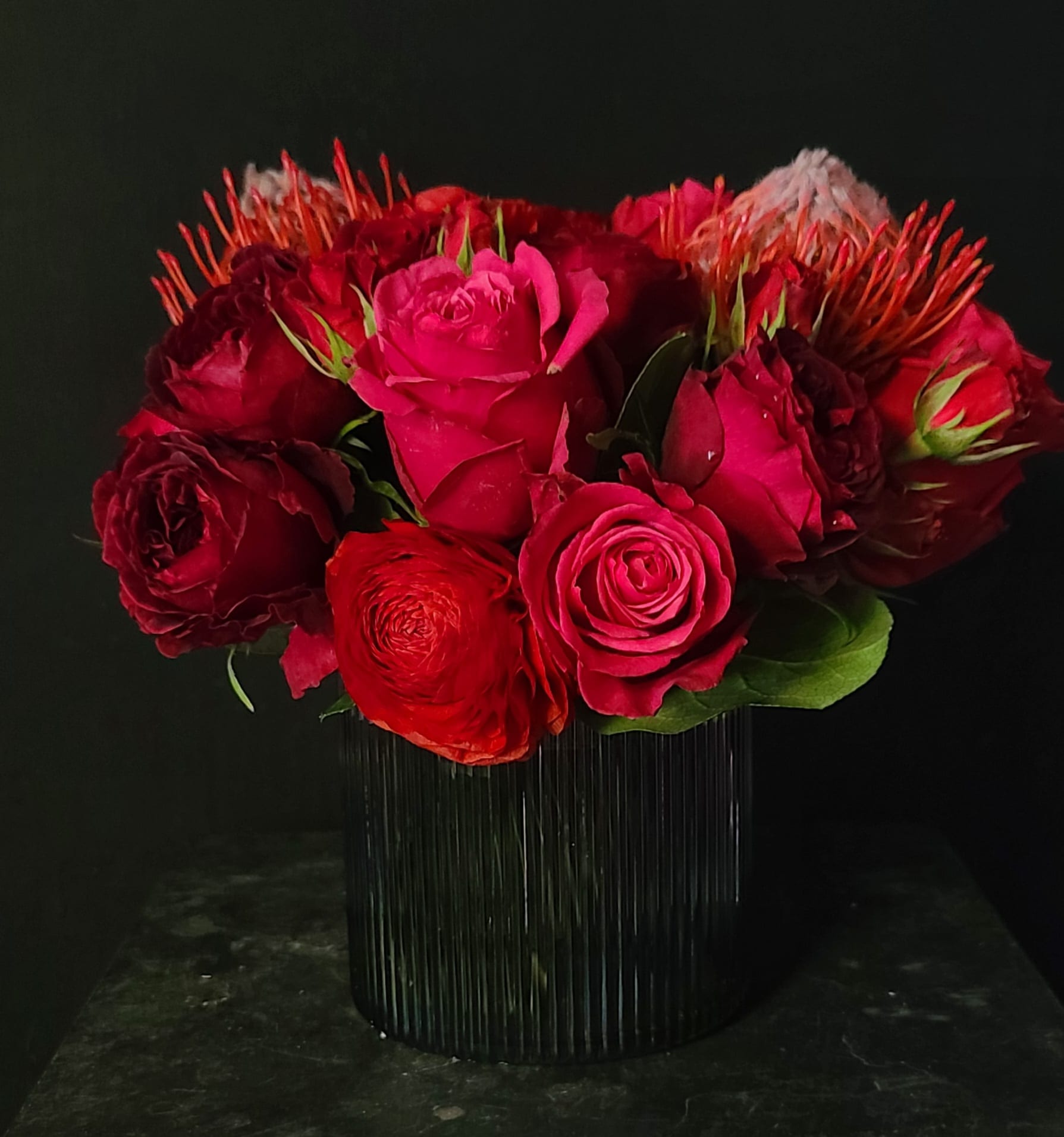 GROOVY KIND OF LOVE - This black opalescent vase is filled with jewel toned florals.  Nothing speak more romance 