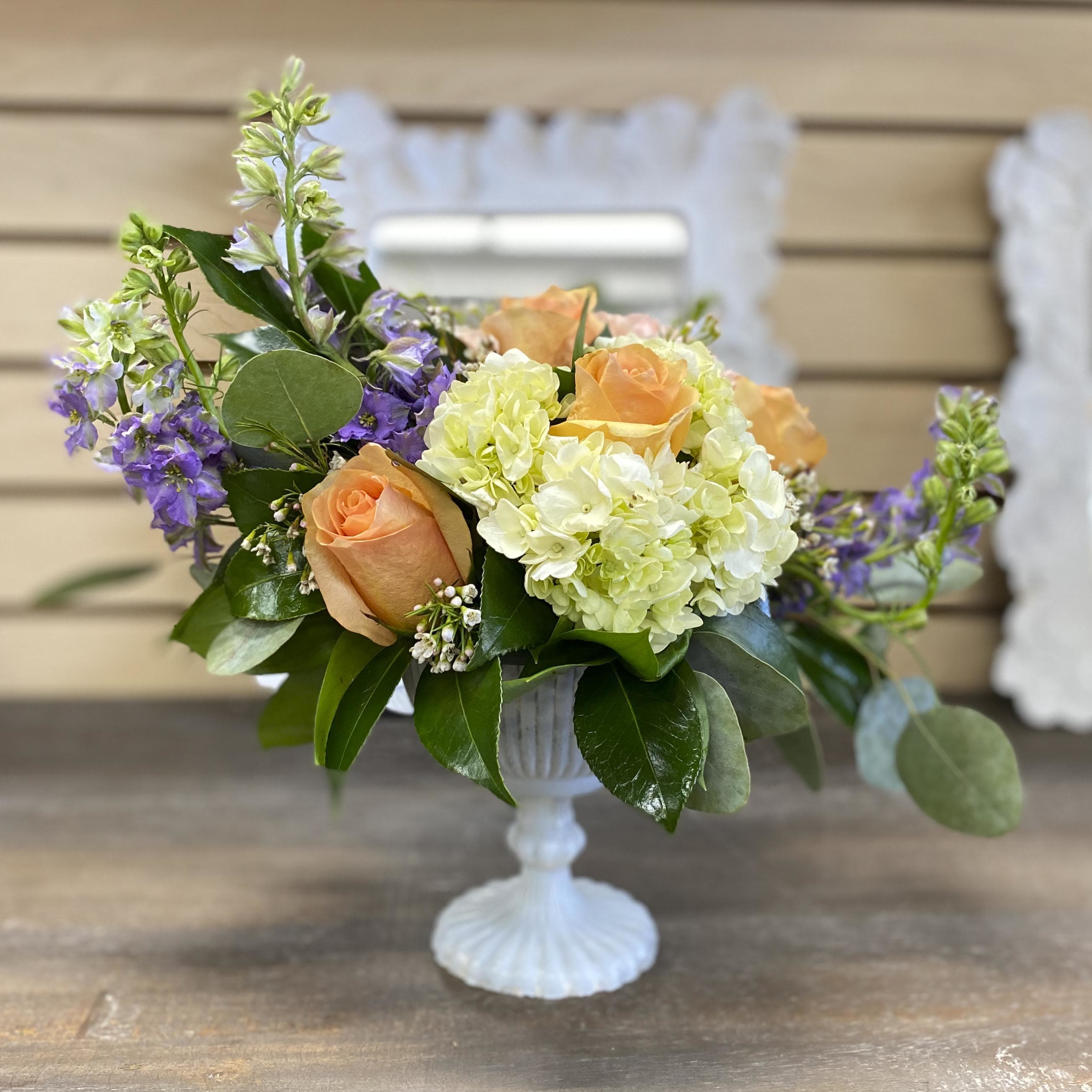 SIMPLY YOU - The glow of this amazing arrangement of roses, Hydrangeas, and other seasonal flowers and greens will delight anyone's senses!! Approximate dimensions of arrangement  6" tall by 8" wide. ** Vase color may change due to availability.