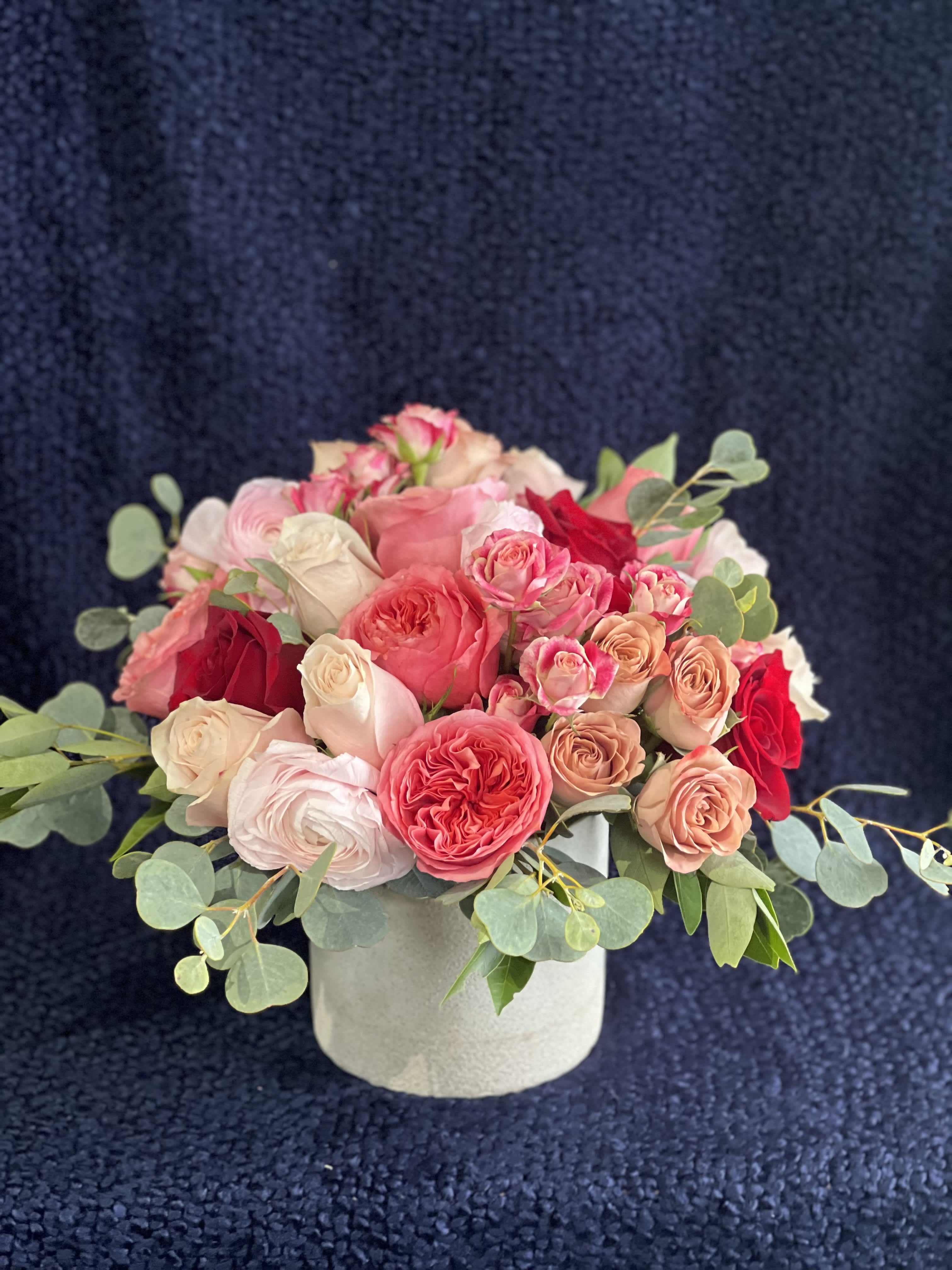 Infatuation - Lovely blending of blush, pinks, reds create a visual treat for your Valentine! Garden roses, ranuculus, sweetpeas. 