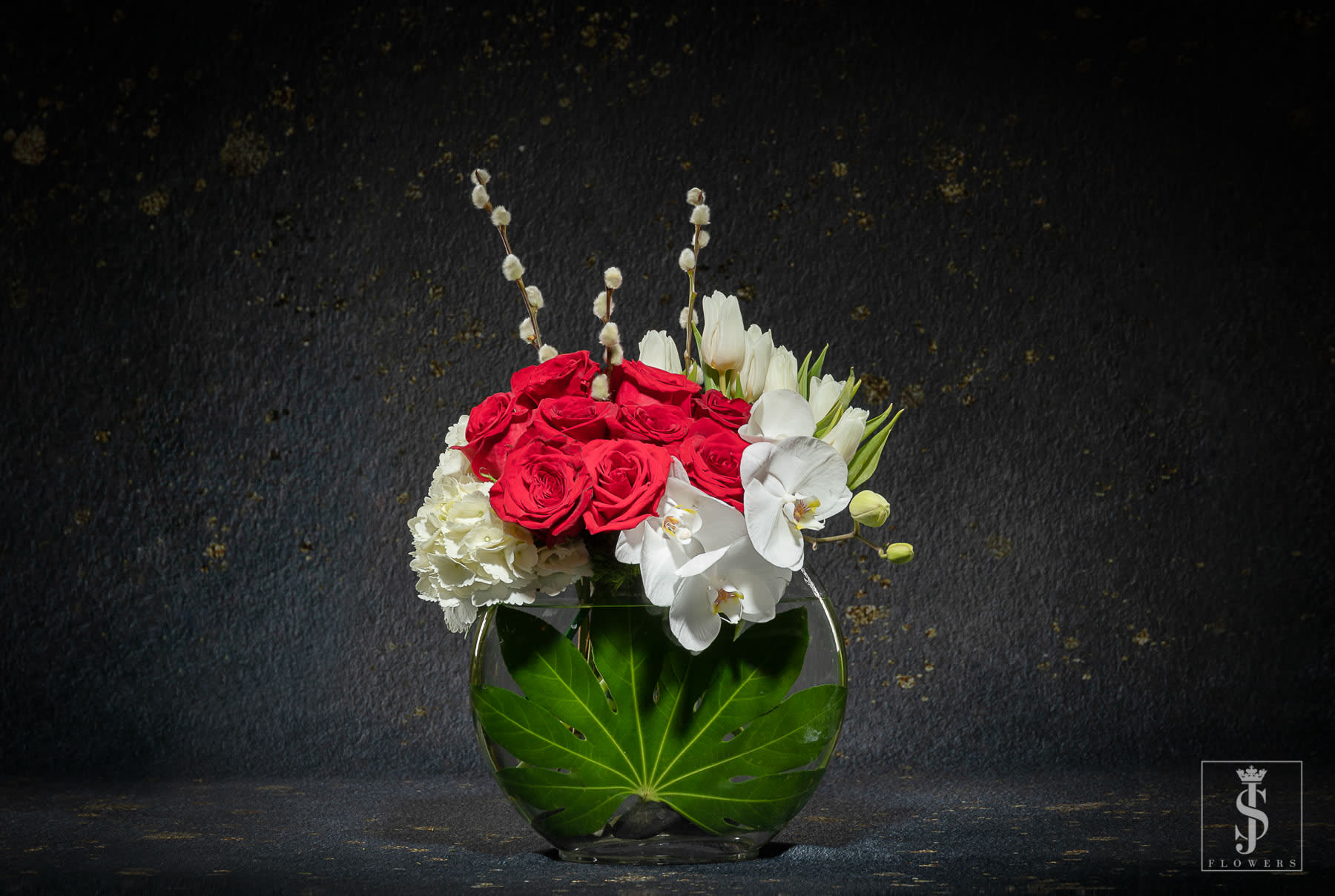 Pure Elegance  - White hydrangeas, Red Roses, Tulips, Orchids with a little textured pussy willow is our chic way of being Modern with a touch Tradition, is a classic beauty. Be Different and sent this modern unisex arrangement and explore your pure love. 