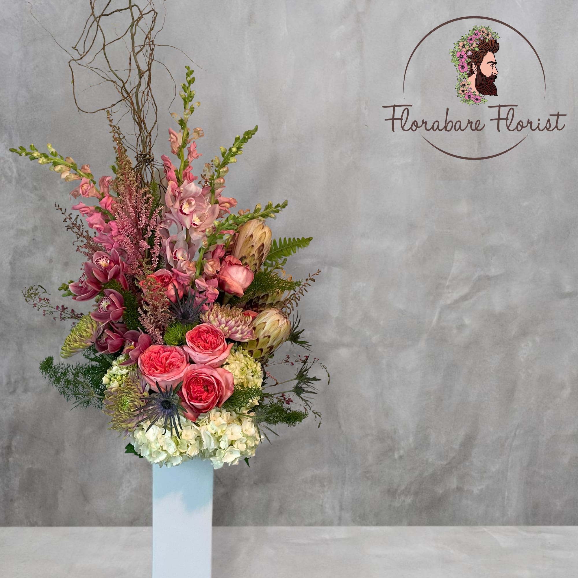 Lush Floral Grand - Lush floral design filled with vibrant colors. Consisting of seasonal flowers and roses. This arrangement can be customized by color or colorful blooms will be hand picked by the designer. (designers choice will consist of the freshest blooms available on hand that day. All flowers subject to substitution by season. VASE MAY VARY)