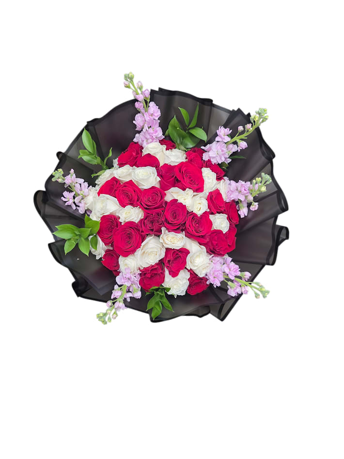 Blush Royale - Blush Royale is a luxurious floral arrangement designed to make a lasting impression. Featuring a harmonious blend of rich red roses and soft ivory blooms, it’s accented with delicate pink florals and elegant butterfly details that add a touch of whimsy and grace. Wrapped in sleek black paper for a bold, modern contrast, this arrangement embodies sophistication, warmth, and timeless beauty. Perfect for celebrating life’s most meaningful moments, Blush Royale is a statement of love, elegance, and heartfelt emotion.