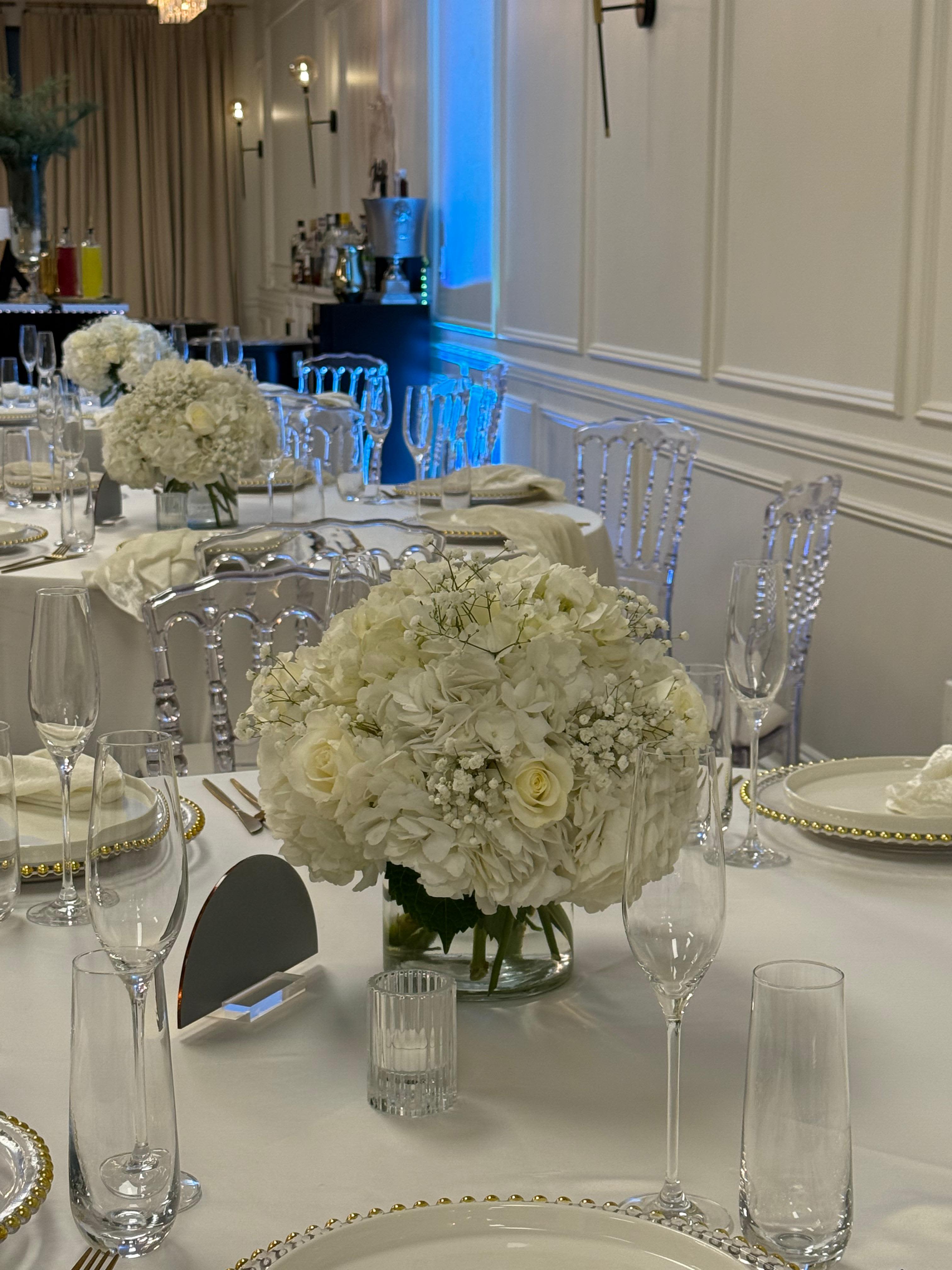 Classic Elegance - This romantic arrangement blends full white hydrangea with creamy roses and airy accents, creating a sophisticated centerpiece ideal for weddings and upscale celebrations.