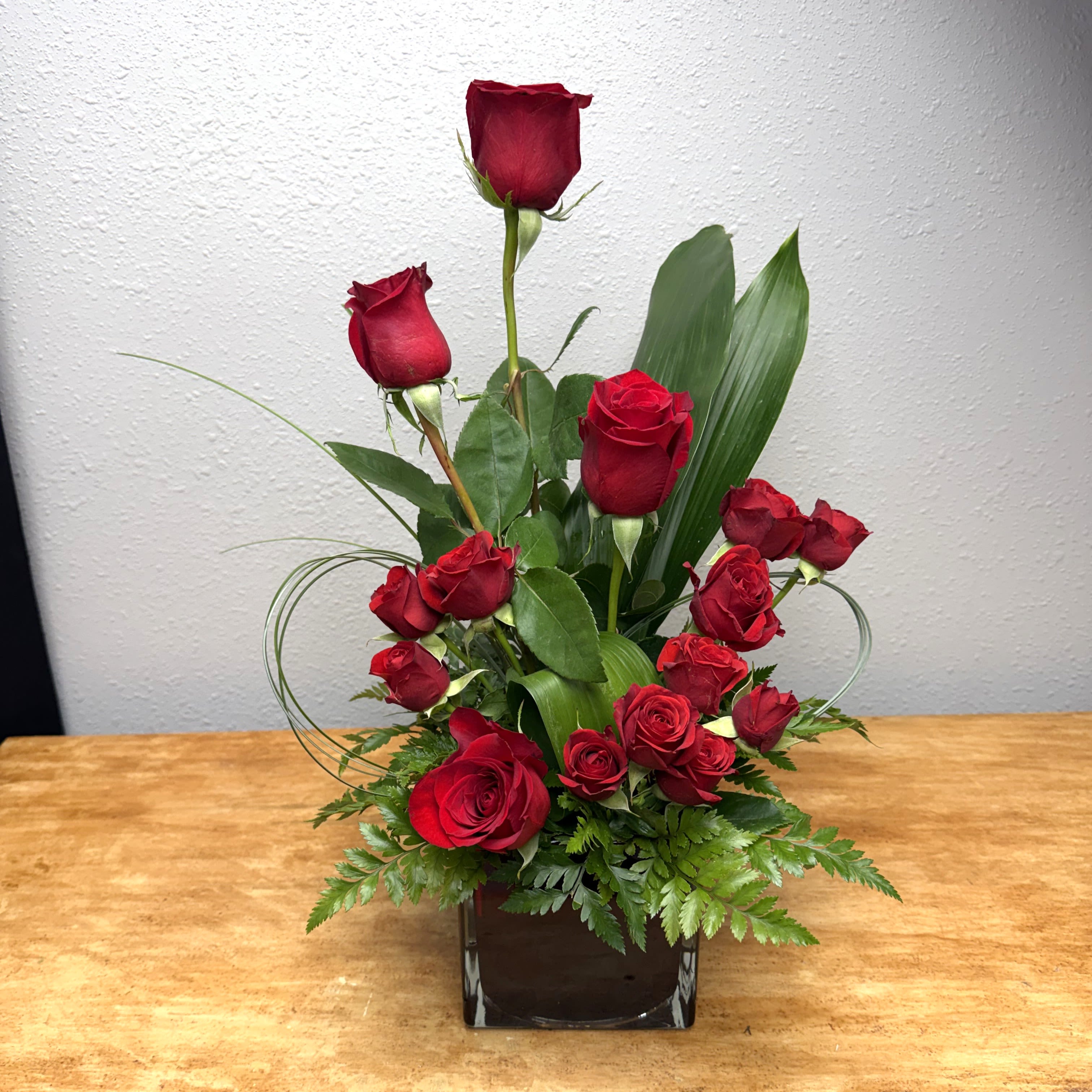 True Love - A striking arrangement of rich red roses, designed in a modern, sculptural style and accented with lush greenery. True Love is a classic Valentine’s statement—elegant, passionate, and unforgettable.