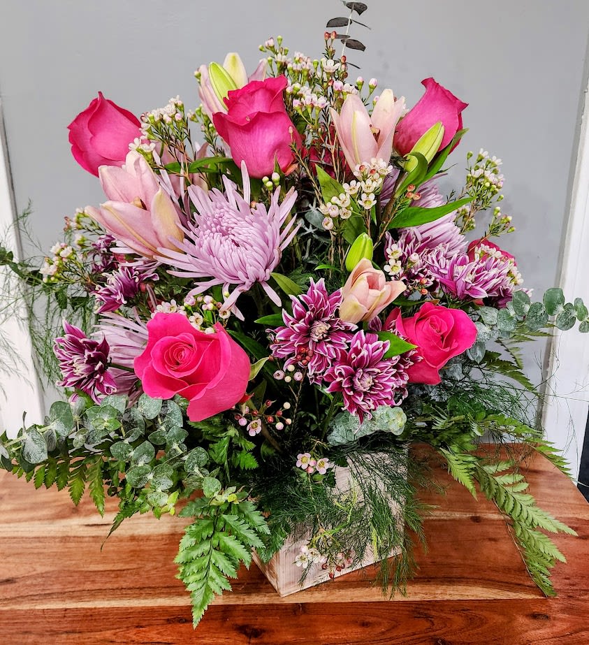 Pink Passion - This Arrangement has Beautiful Hot pink roses blush pink lillies. Mixed with delecate purpleand pink flowers. mixed greenery. 
