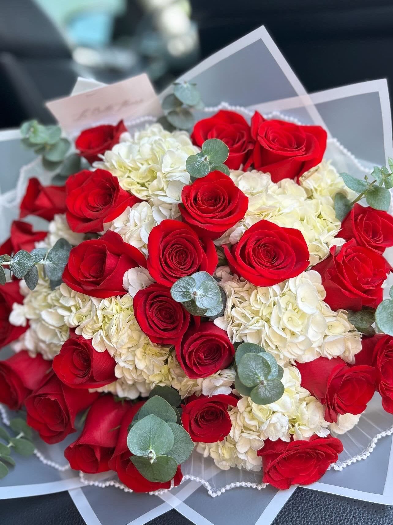 Lina - A mix of red roses and hydrangeas wrapped also available in vase arrangements 