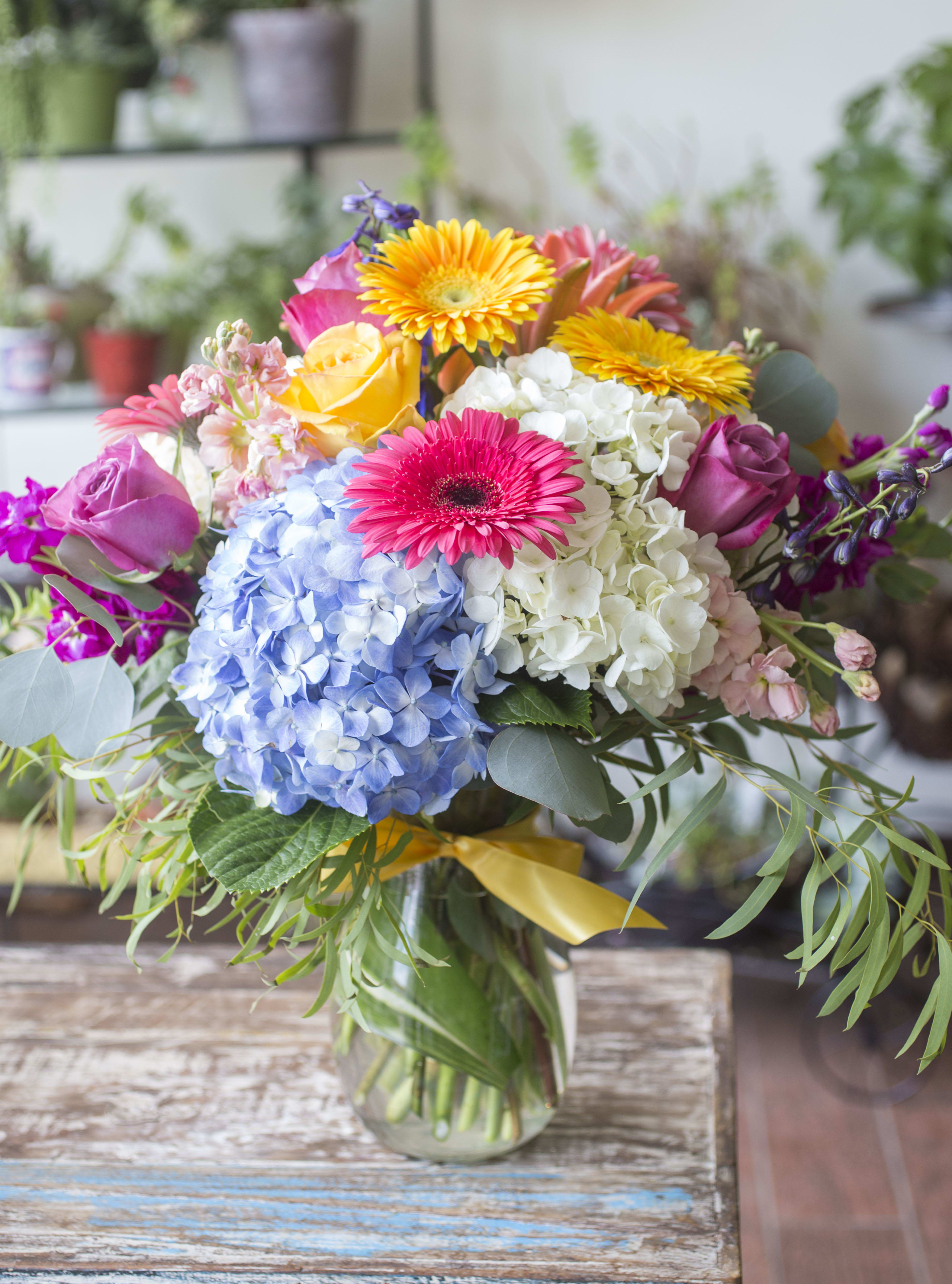 Avila - Colorful bliss! Hydrangea, Roses, Gerbera Daisies and Stock with seasonal accents, arranged in a clear glass vase.