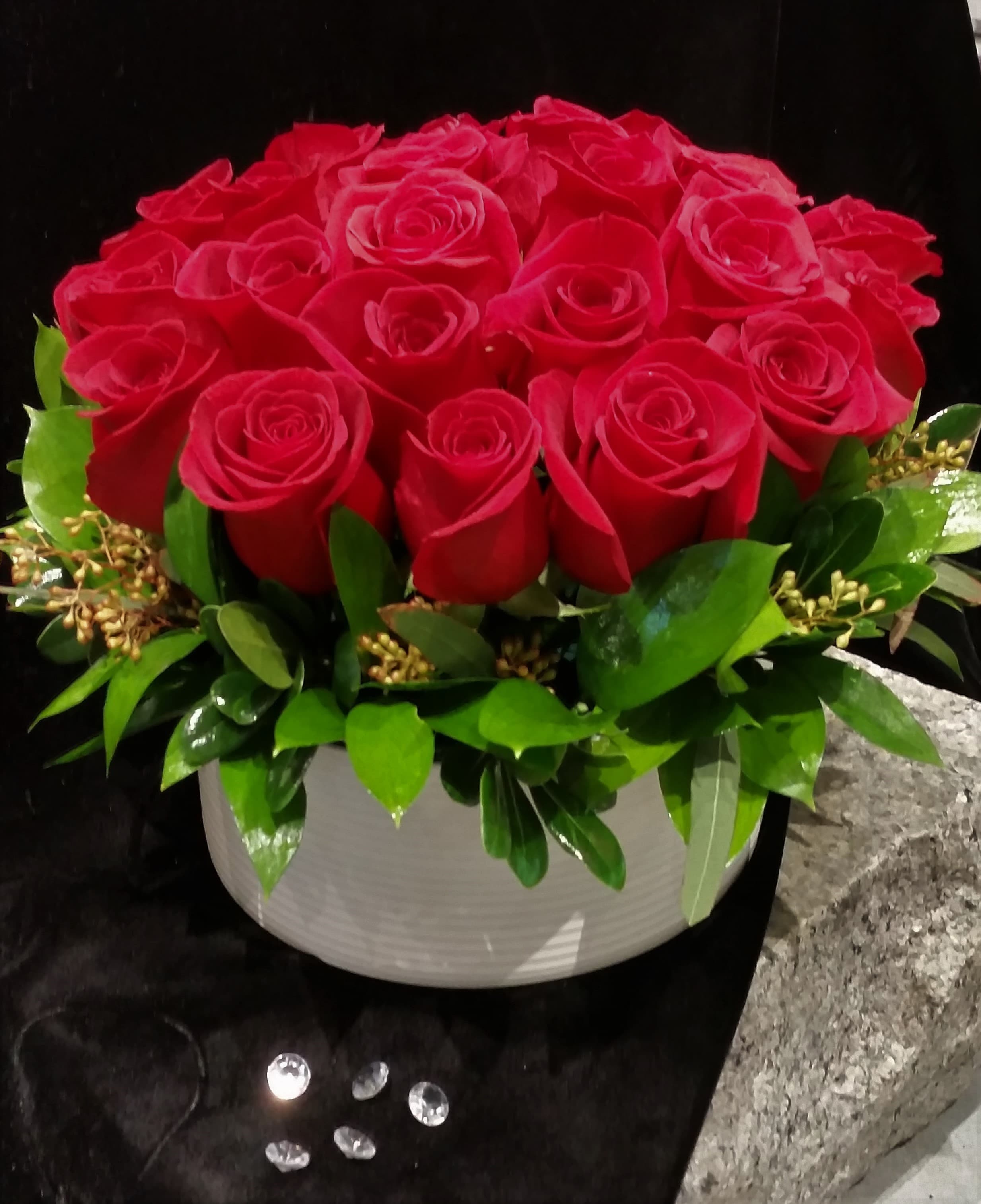  Crimson Luxe Rose Hedge - Eighteen premium red roses from one of the best Ecuadorian rose farms skillfully arranged in a contemporary, classy white designer bisque bowl.  The height of elegance, luxury and romance!