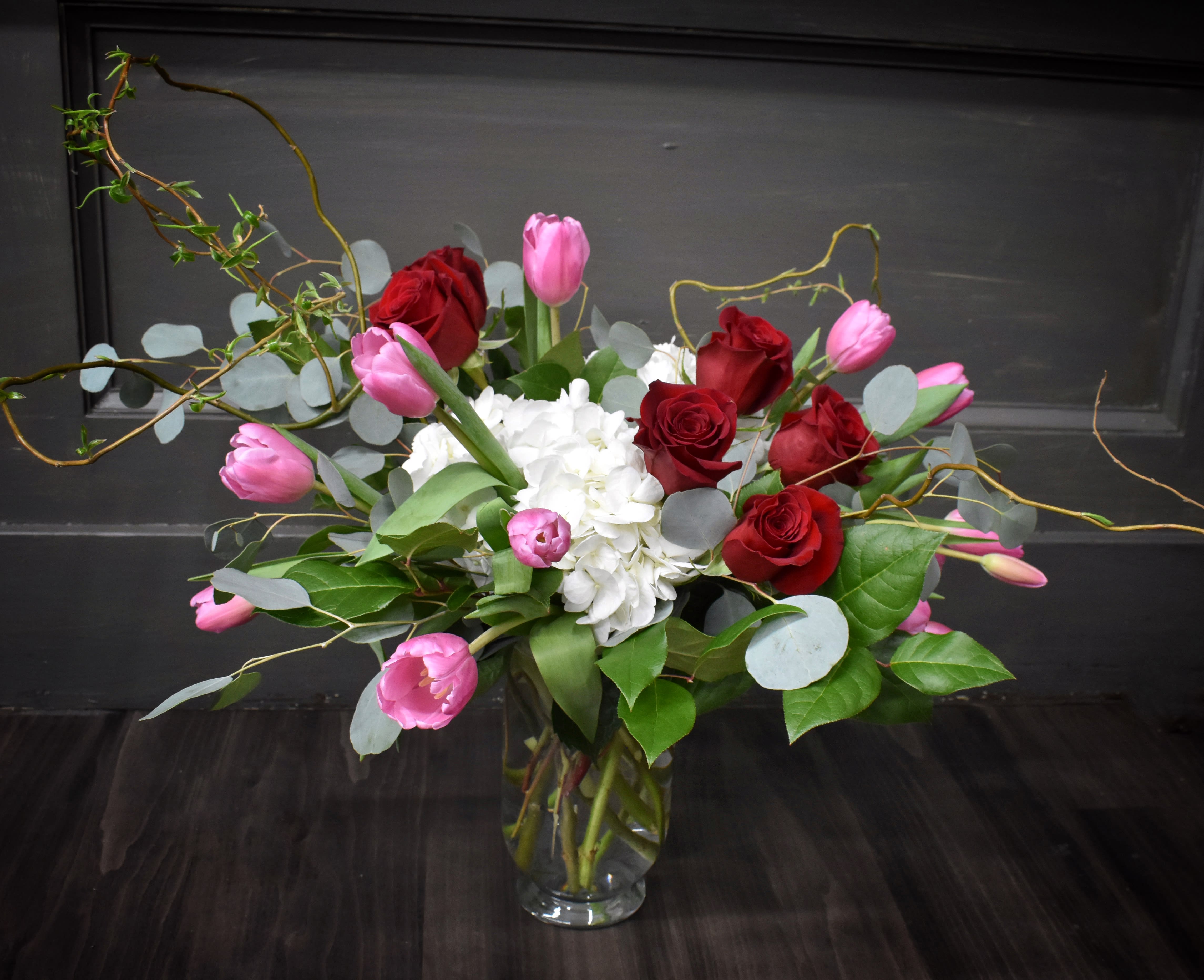 Pretty Wonderful - This bouquet is simply beautiful! We've created it with 15 tulips, red roses and white hydrangea with assorted green foliages and curly willow.
