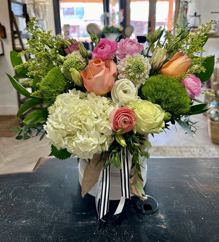 Pure Love - A beautiful mix of hydrangea, peonies, tulips, roses, and snapdragons in a hat box.