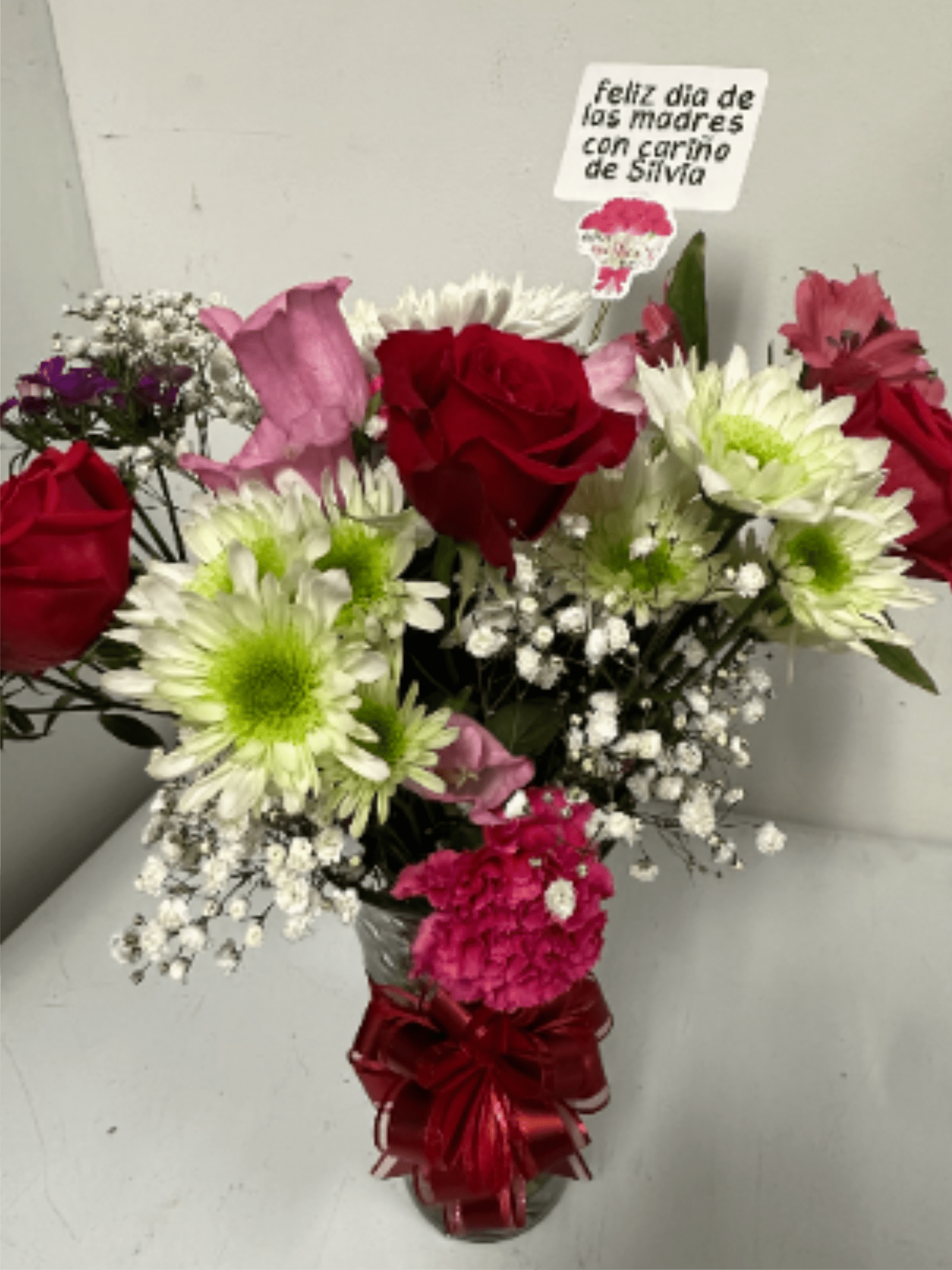 Floral arrangement with different flowers in a glass container and ribbon, a detail for all kinds of occasions - Floral arrangement with different flowers in a glass container and ribbon, a detail for all kinds of occasions