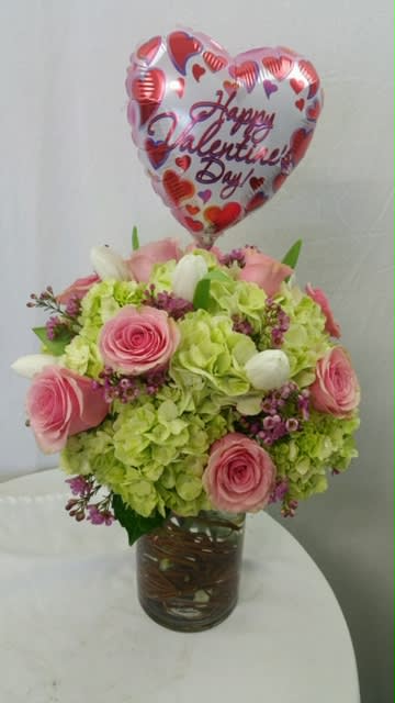 Valentine's Wishes Bouquet - This isn't your ordinary pink and red bouquet, which makes this a very special piece for your Valentine. Includes a mix of fresh roses, tulips and hydrangea. Elegant, beautiful and wonderful. Also includes a mylar balloon.