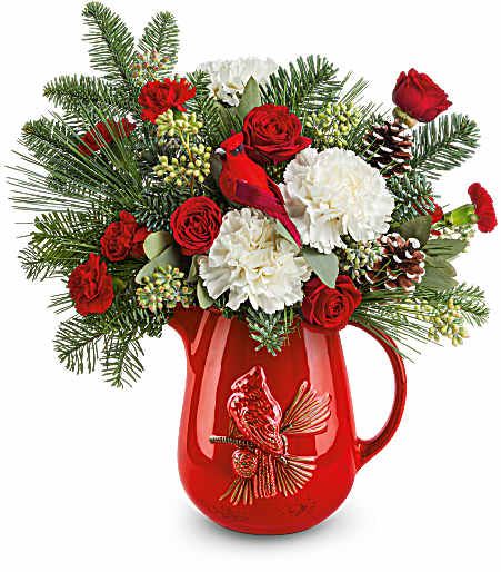 Scarlet Cardinal Bouquet - This brilliant scarlet cardinal pitcher is not only food-safe for festive drinks, it's filled to the brim with wonderfully fragrant seasonal greenery, roses, and carnations! Approximately 13 1/2 inches wide and 14 1/2 inches tall for the Standard size.
