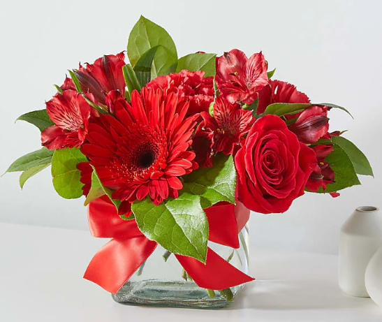 Ruby Romance - This gorgeous monochromatic filled cube vase features roses, carnations, and alstroemeria lilies.