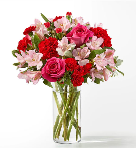 You're Precious  - Blushing shades of pink blooms are nestled in lush greens to charm anyone's day. This bouquet is abundant with a classic assortment of pretty florals – roses, alstroemeria and carnations to name a few.