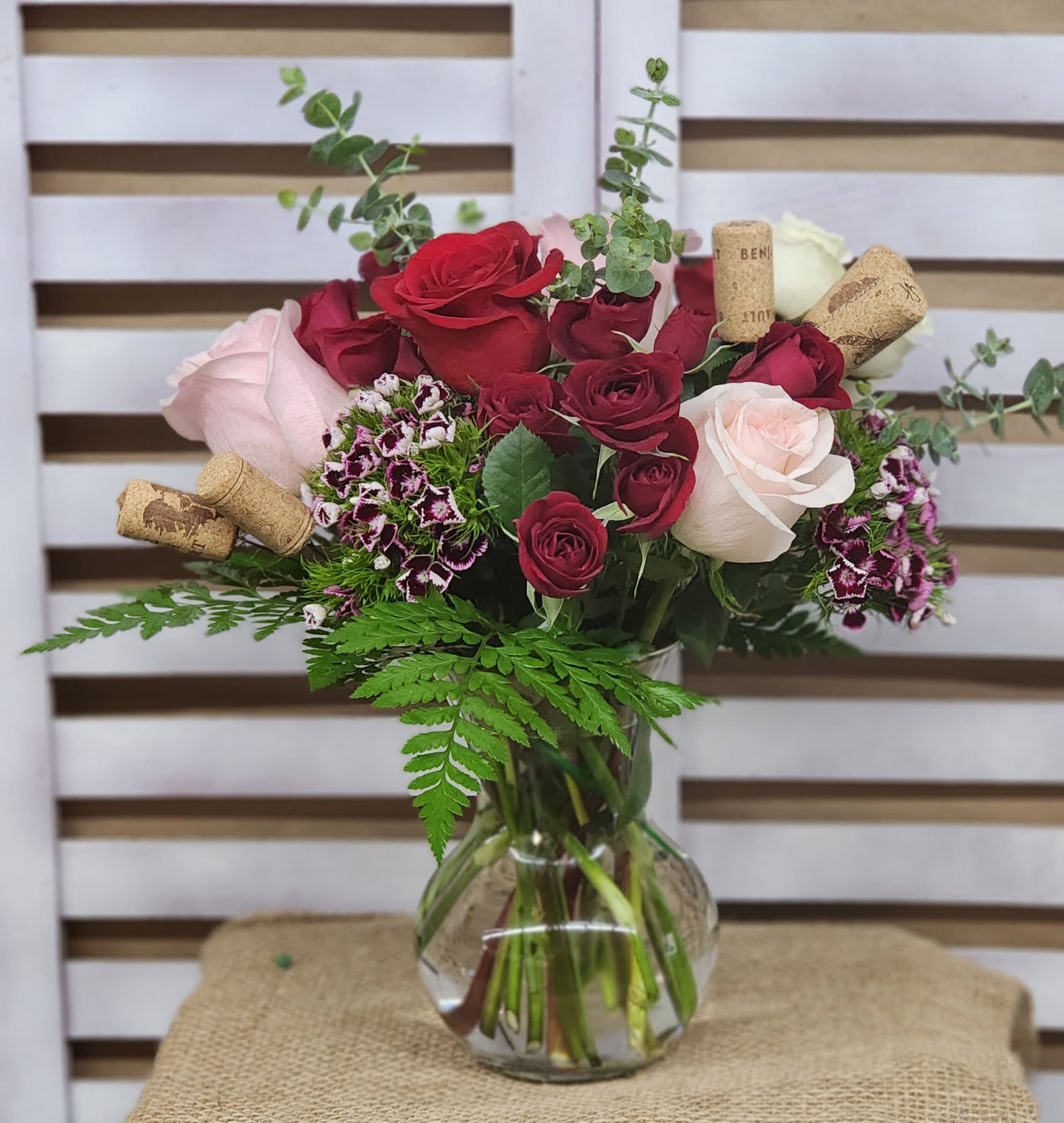 Wine Country - A bold blend of red, pink and white roses, paired with spray roses and hints of sweet william are sure to bring a smile to your loved one's lips! The perfect gift for HER. 