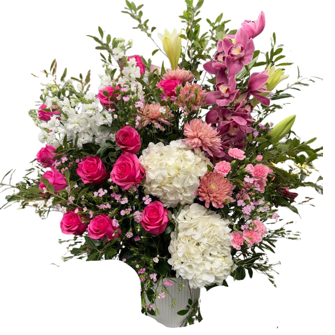 Pretty in Pink XL - A lush, garden-style statement arrangement bursting with hot pink roses, white hydrangeas, orchids, and soft seasonal blooms, layered with airy greenery and delicate filler for that “just-picked” look. Fun, flirty, and seriously impressive  perfect for birthdays, celebrations, and big entrances.