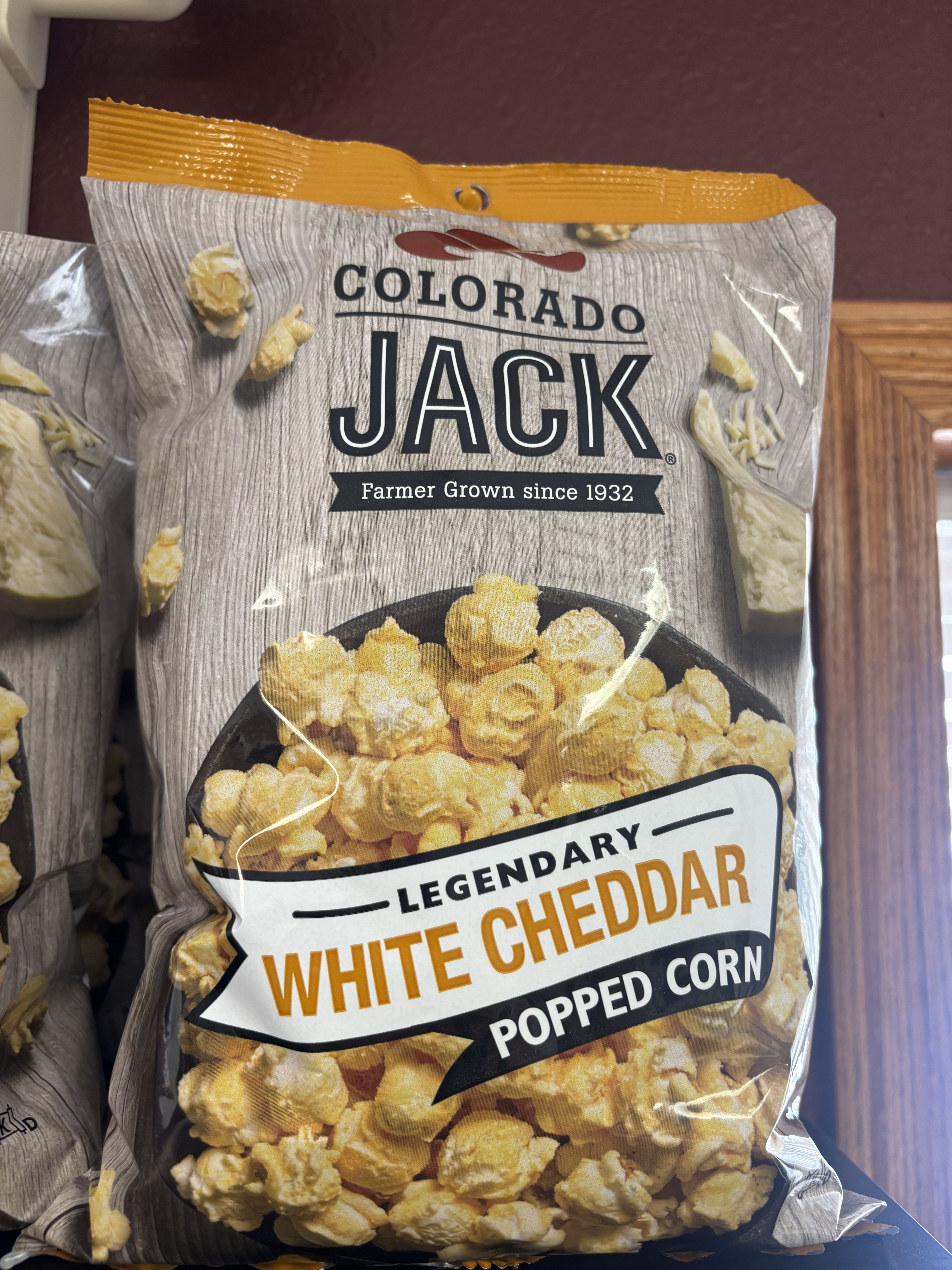 Colorado Jacks White Cheddar Popcorn  - Light, fluffy popcorn generously coated in rich, creamy white cheddar for a bold yet perfectly balanced flavor. Colorado Jack’s Legendary White Cheddar Popped Corn delivers a satisfying crunch with a smooth, cheesy finish in every bite. Made with farmer-grown corn and crafted for true snack lovers, it’s an irresistible treat for movie nights, gifting, or anytime cravings call for something savory and special.