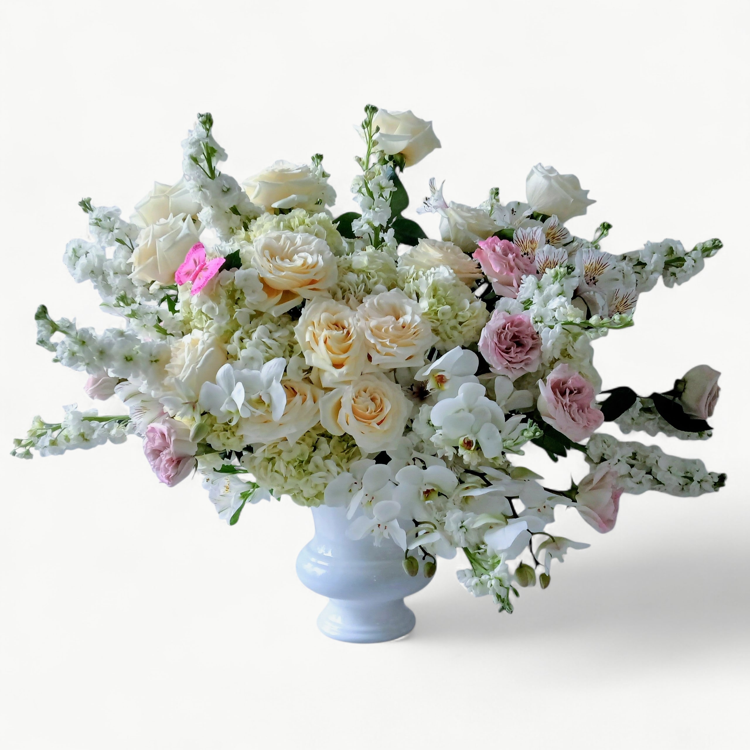 Couture White Rose &amp; Orchid Sympathy Spray - A opulent and emotionally designed lavish display of premium white roses, long cascading Phalaenopsis orchids, lush white hydrangeas, soft lavender and blush pink garden roses all arranged in a beautiful white tall vessel.   This massive display is the ultimate in heart-felt elegance, honoring your special someone in a way that feels ethereal and peaceful.    Please allow 48 hour notice for your order so that we may source the most premium blooms.