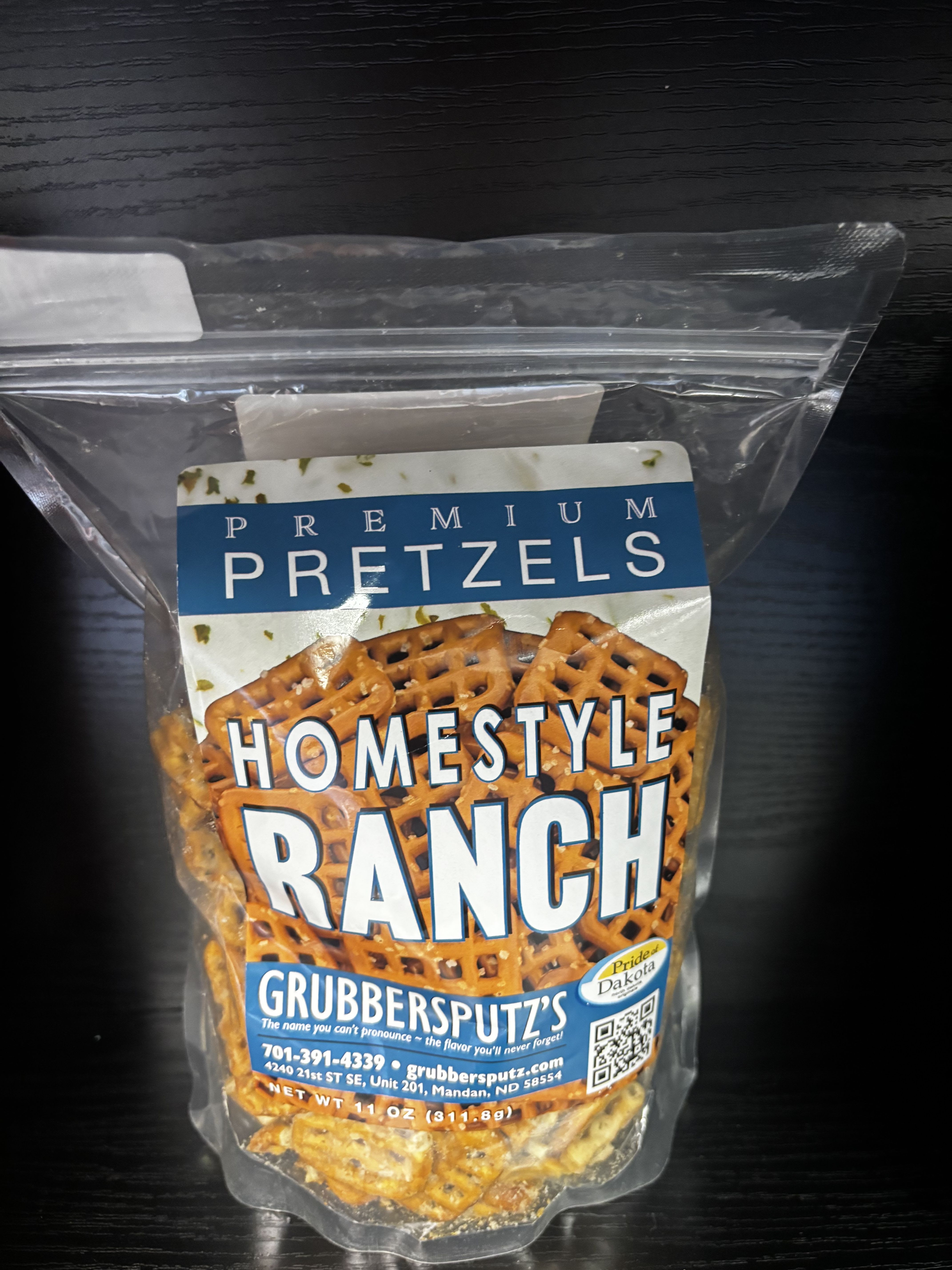 Grubbersputz’s Premium Homestyle Ranch Pretzels - Crispy, golden pretzels coated in a classic homestyle ranch seasoning with savory herbs and creamy tang. Grubbersputz’s Premium Homestyle Ranch Pretzels deliver bold, comforting flavor with a satisfying crunch in every bite. Proudly made in North Dakota and featuring Pride of Dakota products, they’re perfect for ranch lovers, party snacking, or adding a flavorful local favorite to gift baskets.