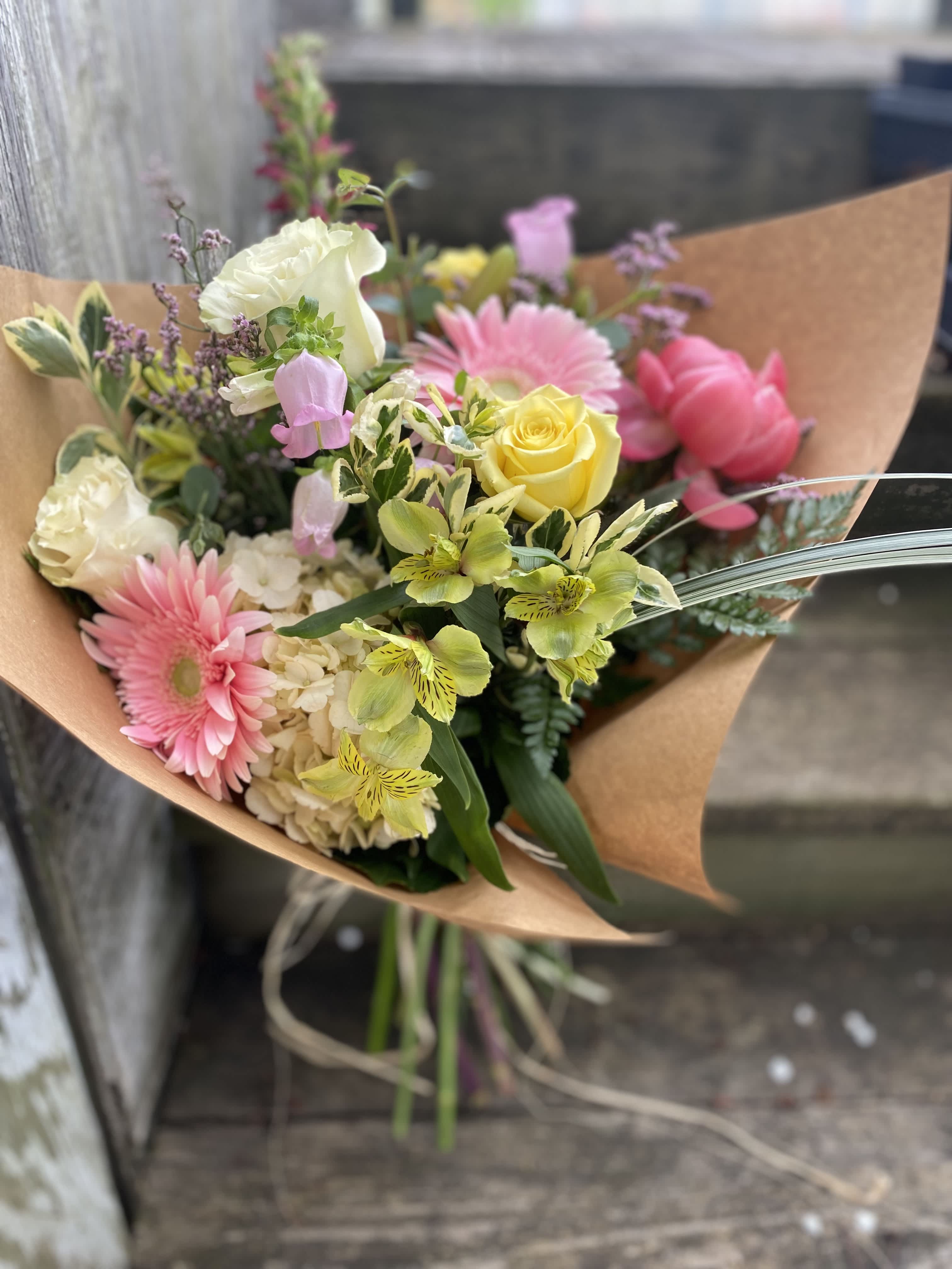 Wrapped Bouquet - A bundle of fresh flowers in seasonal colors, hand tied and wrapped.   Please note, these photos are meant to serve as an inspiration for color and style. Due to the seasonality of flowers, these arrangements cannot always be identically replicated.    Please contact us at 607-257-3203 with any questions.