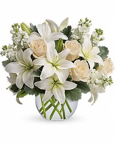 Isle of White - Like a vacation for the senses, this lovely bouquet delivers an oasis of beauty and elegance. Soothing, serene and very special. CrÃ¨me roses, white asiatic lilies and stock stem are incredibly arranged in a bubble vase. When it comes to bouquets, this is definitely the right way to do white.