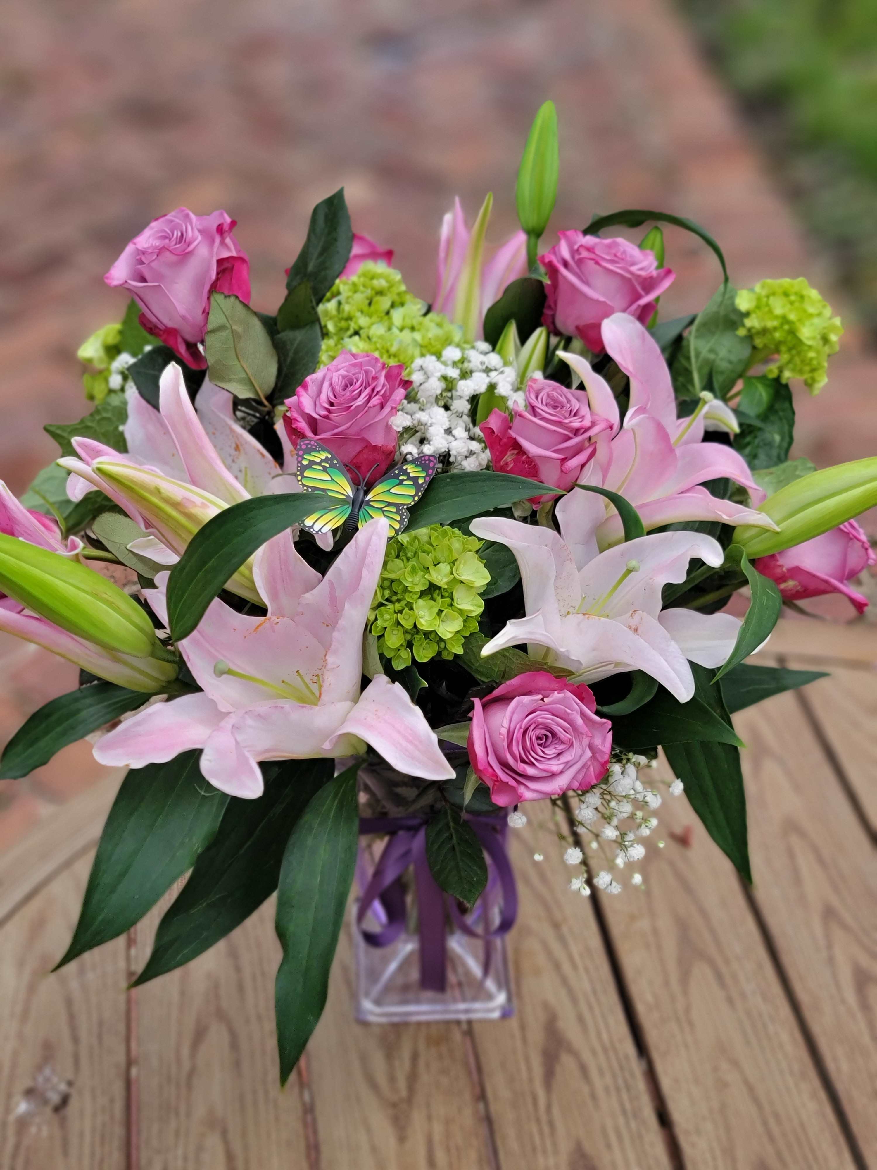 Lavender Haze - This dramatic arrangement includes stunning roses, lilies &amp; mini hydrangeas with the perfect mix of lavender filler and greens Send this stunning bouquet for any occasion.