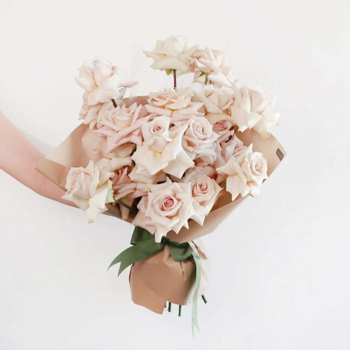 QUICKSAND - One dozen buttery blush quicksand roses wrapped with accenting greenery. 