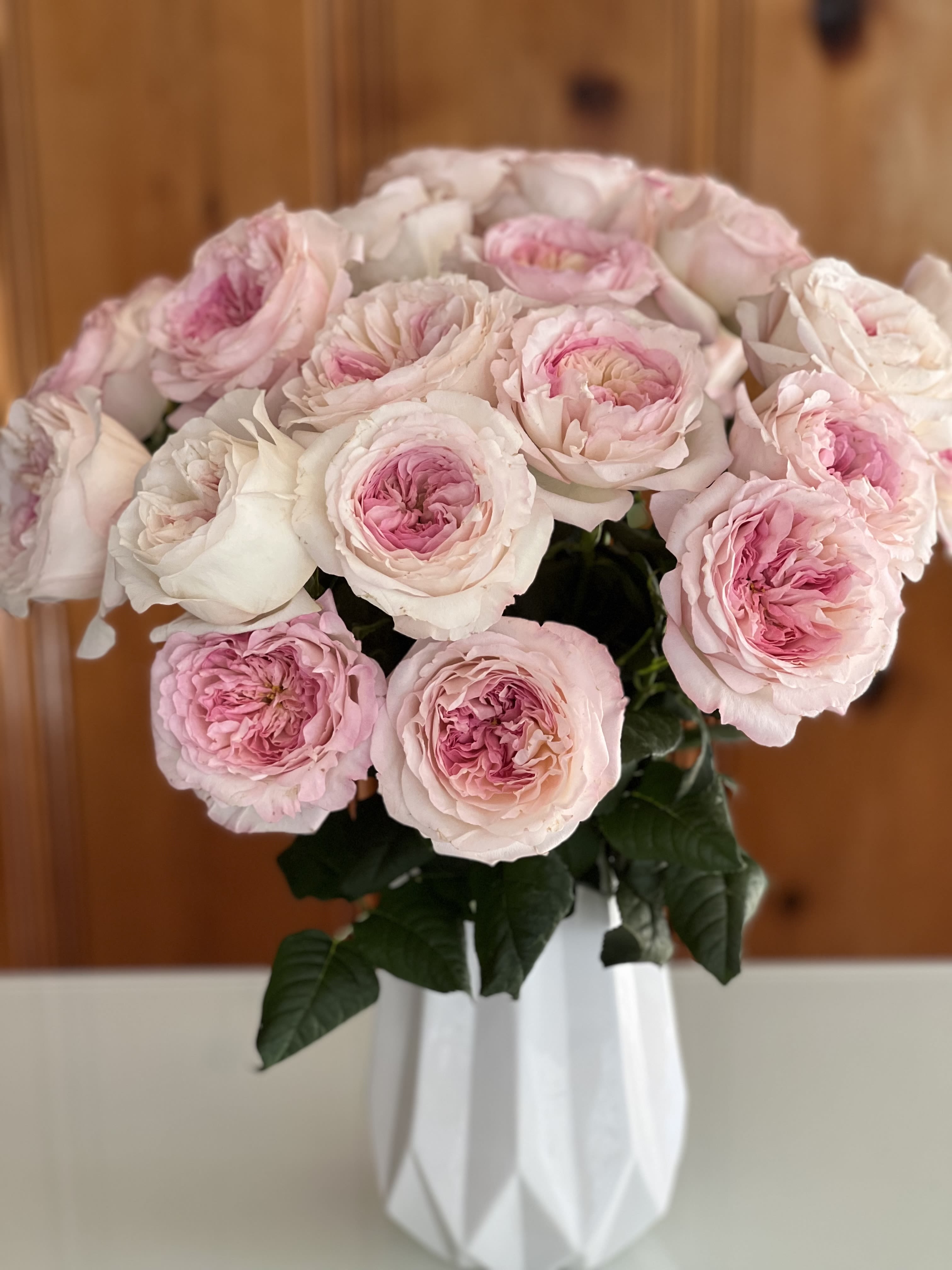Keira  - Two Dozen Keira Garden Roses  An embodiment of quiet luxury, this arrangement showcases two dozen Keira garden roses, revered for their opulent, ruffled petals and soft blush-to-ivory hues. Generous petal count, revealing a romantic rosette form and a delicate, old-world fragrance that evokes the elegance of an English garden in full bloom.  Hand-selected at peak perfection and artfully arranged, Keira roses are prized for their luminous depth, painterly texture, and timeless femininity. The abundance of blooms creates a statement of refined indulgence—lush yet restrained, classic yet unforgettable.  Perfect for marking life’s most meaningful moments, this arrangement speaks in the language of grace, devotion, and enduring beauty. A true heirloom floral experience, designed for those who appreciate rarity, craftsmanship, and effortless sophistication.
