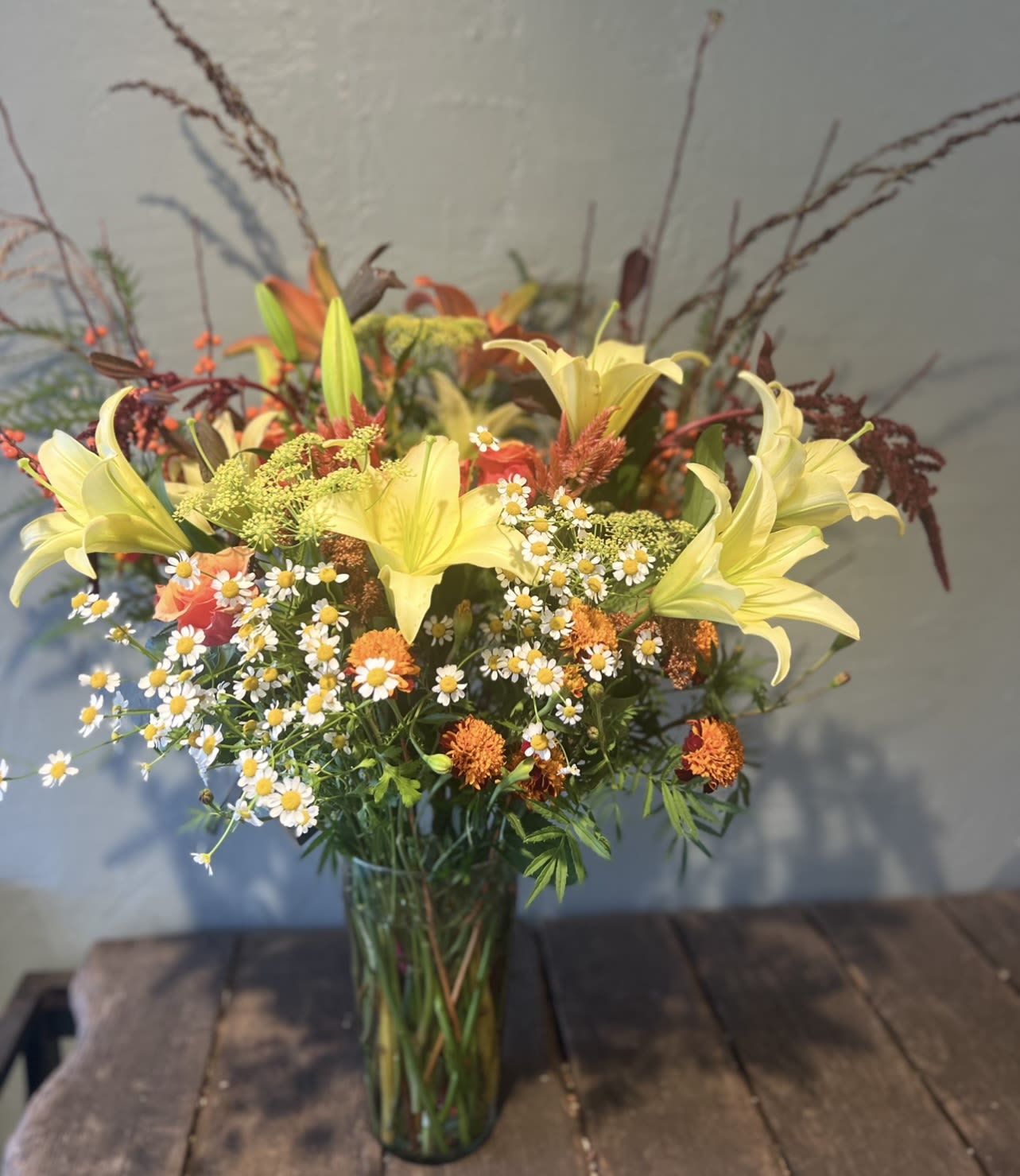 Morning Hush  - A soft and airy arrangement of creamy white blooms, graceful lily buds, and fresh seasonal greenery. Designed with natural movement and lightness, Morning Hush captures the calm beauty of early light—gentle, elegant, and quietly luxurious. 