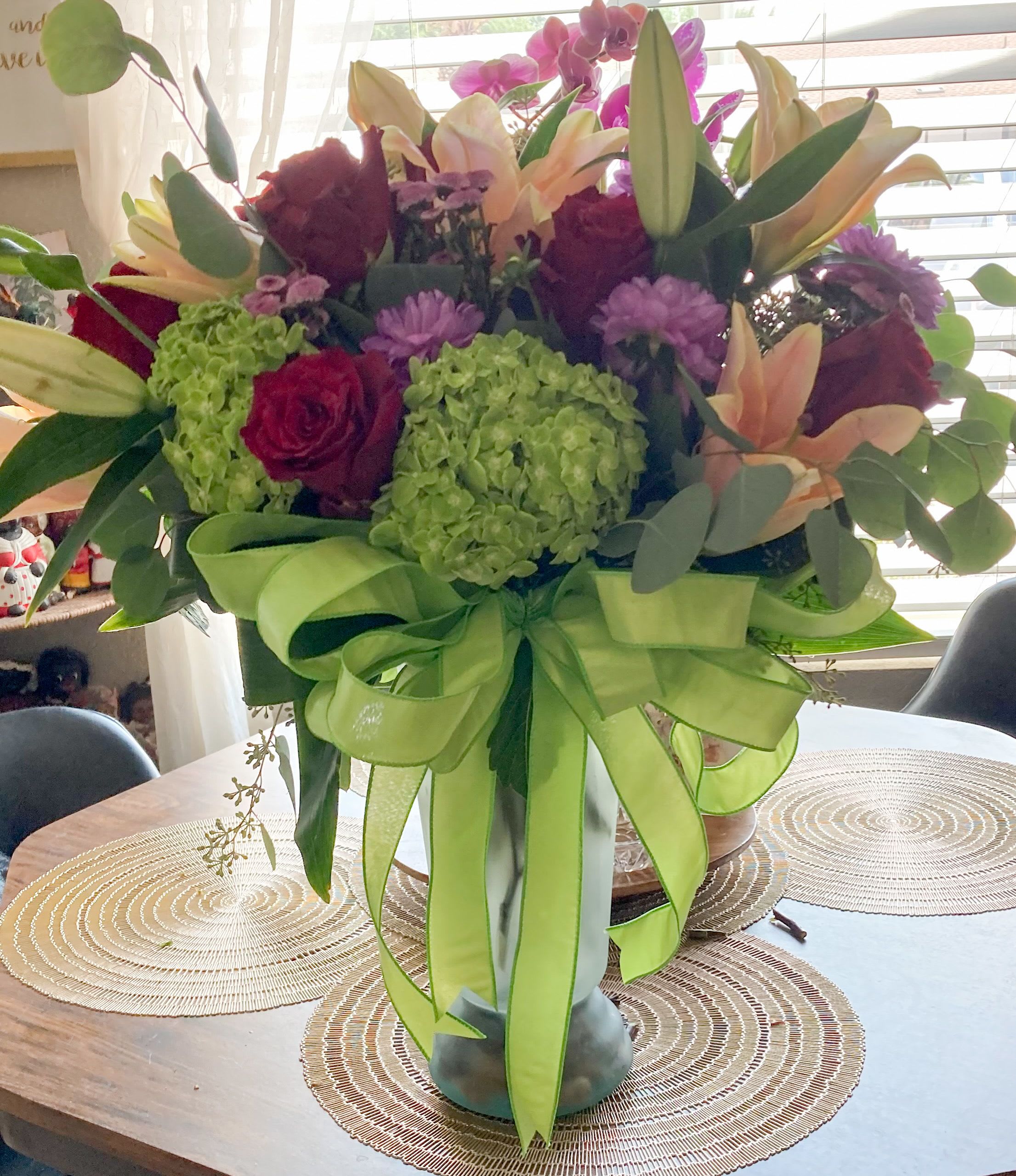 Bold &amp; Green - Assorted colorful seasonal blooms in a custom vase.